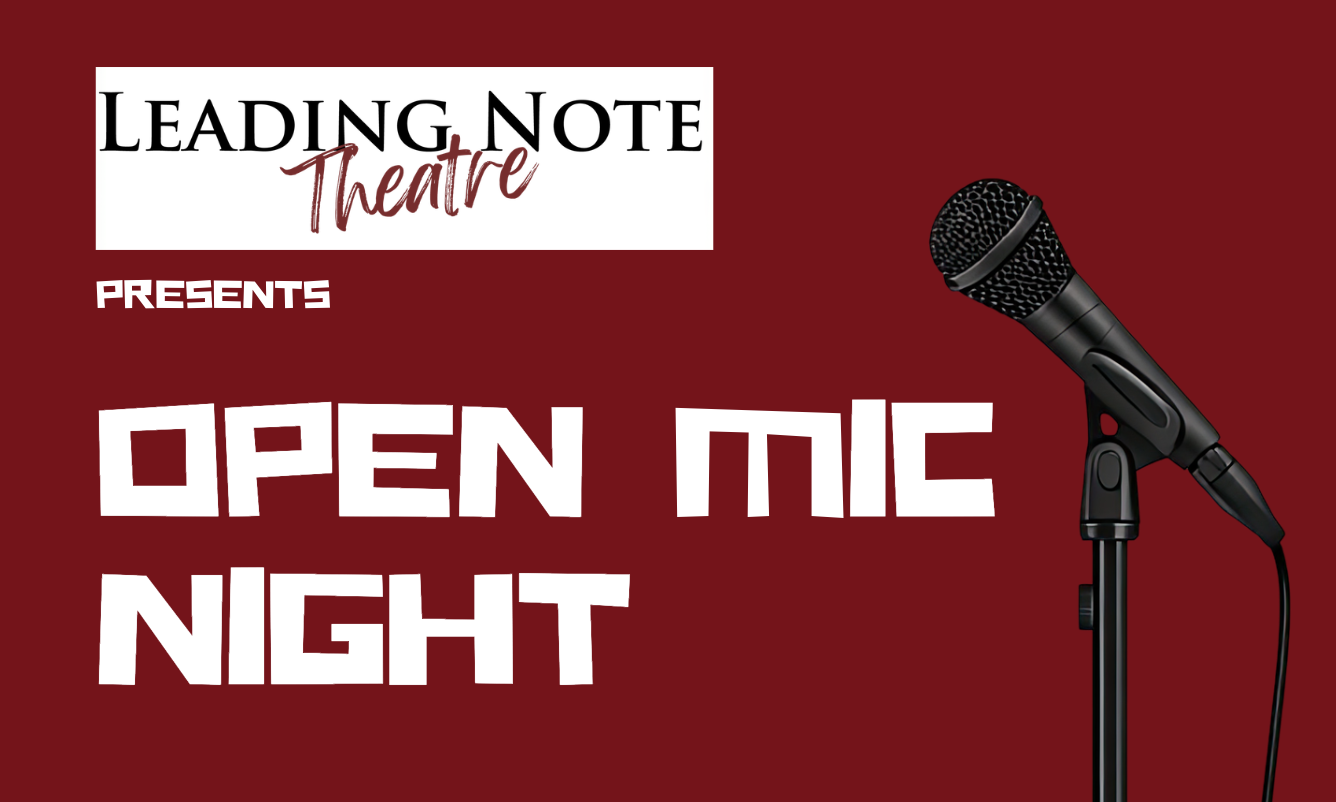 Microphone standing on a stage with bright lights in the background.