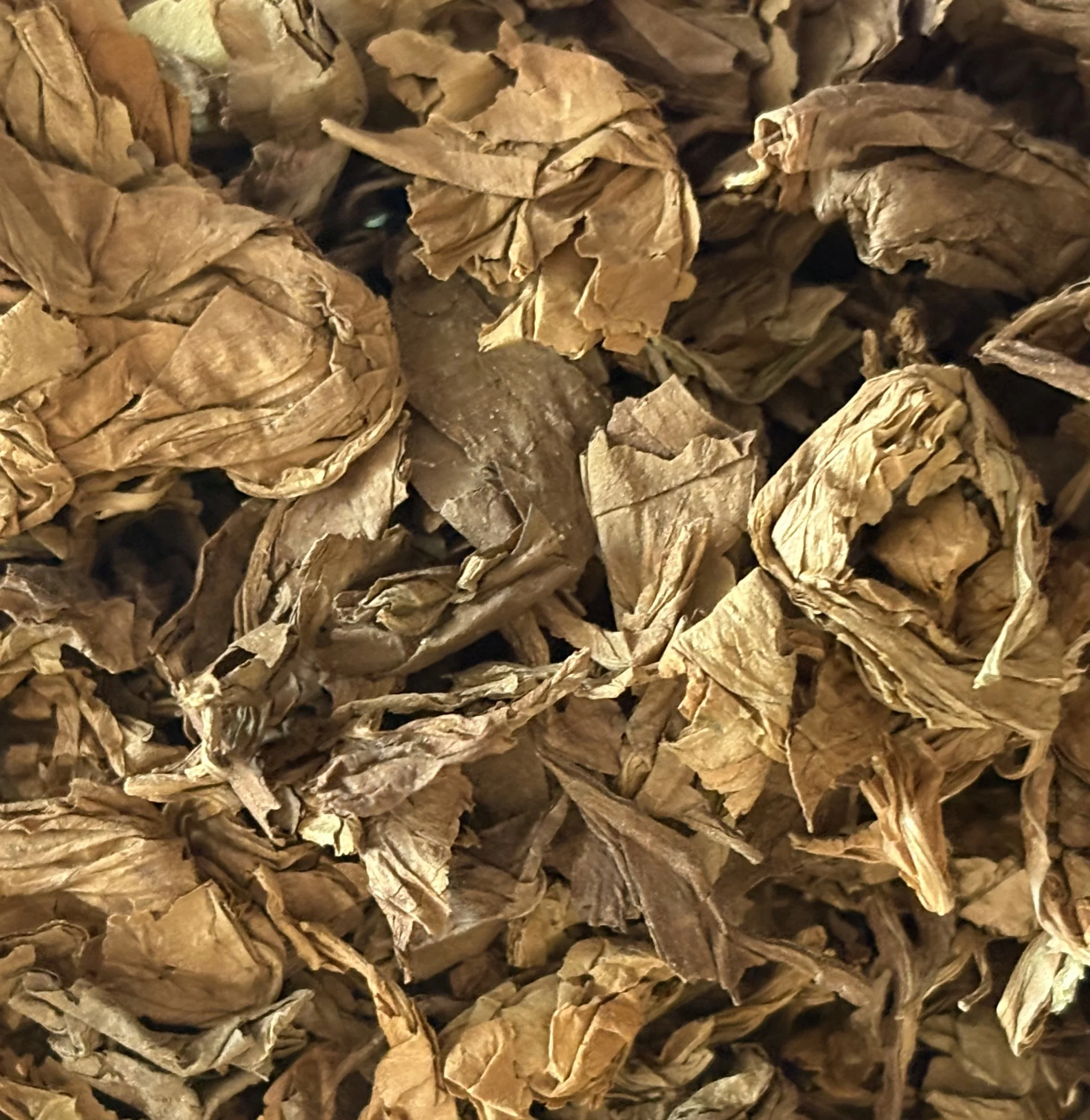 Close-up of dried, crumpled tobacco leaves.