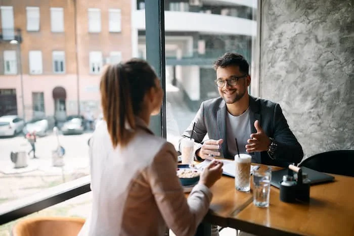 Business colleagues eating breakfast at a cafe.