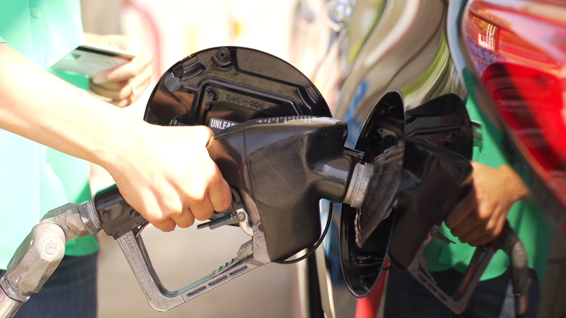 Additech fuel additive being automatically injected into fuel stream as vehicle refuels