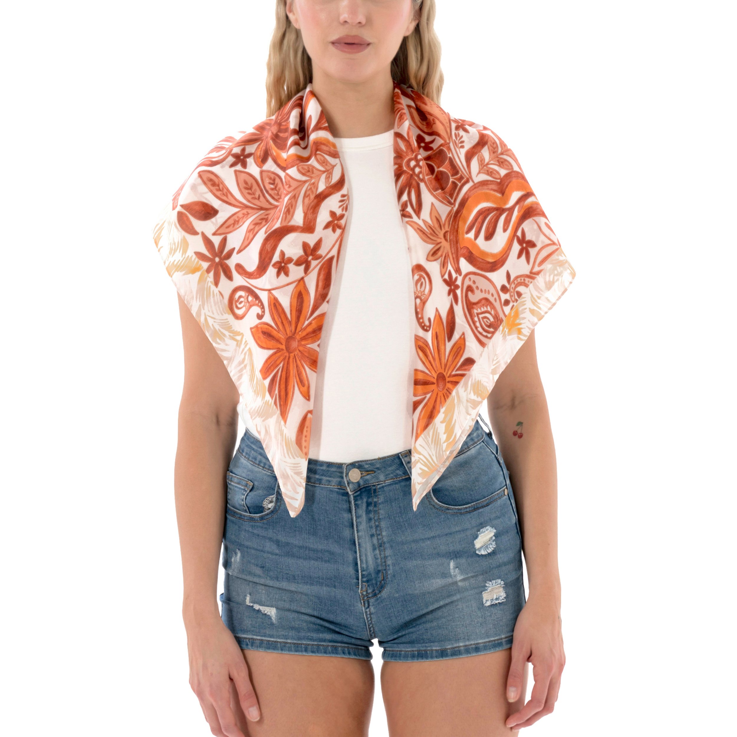 Woman wearing a white top, distressed denim shorts, and a floral patterned scarf in orange and cream colors.