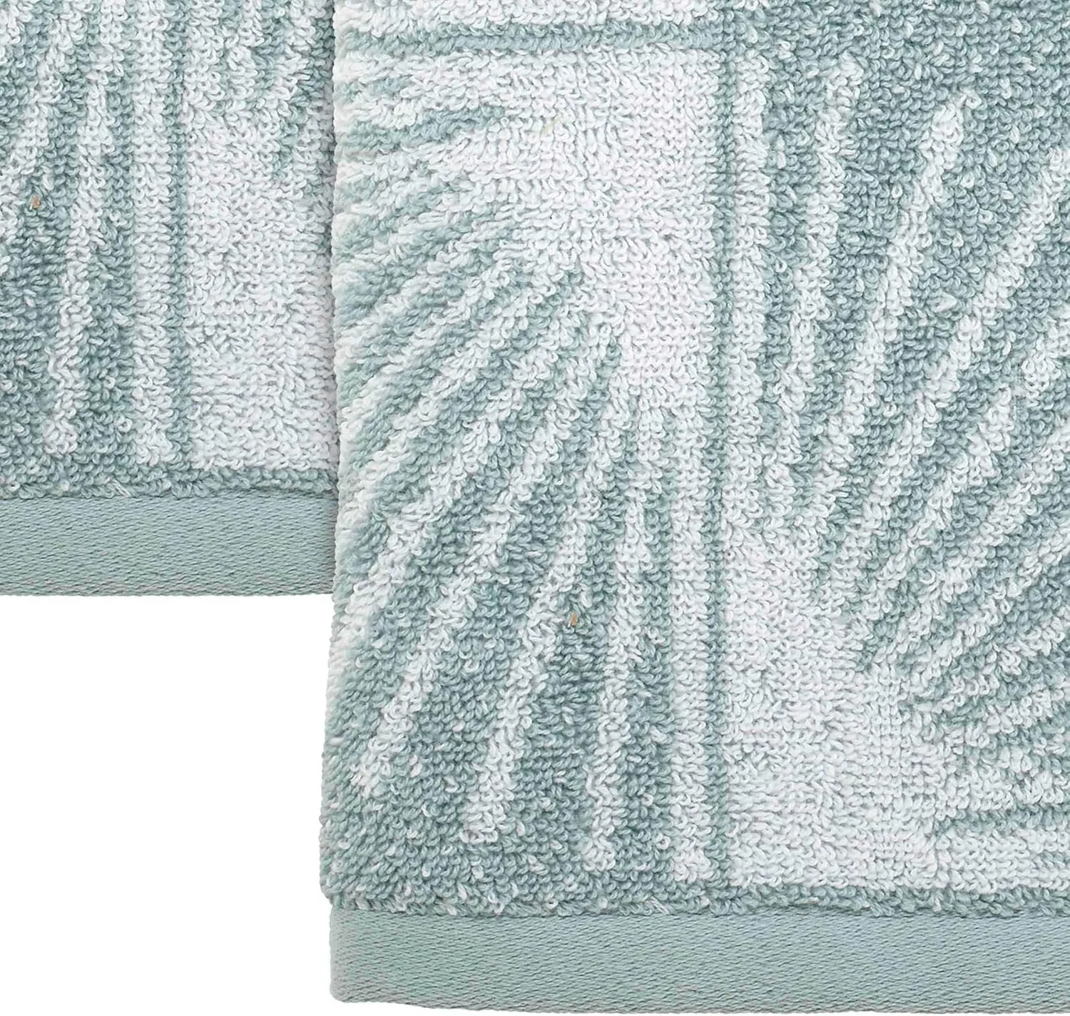Close-up of a light blue and white fluffy bathroom towel with textured loops and a smooth border at the bottom.