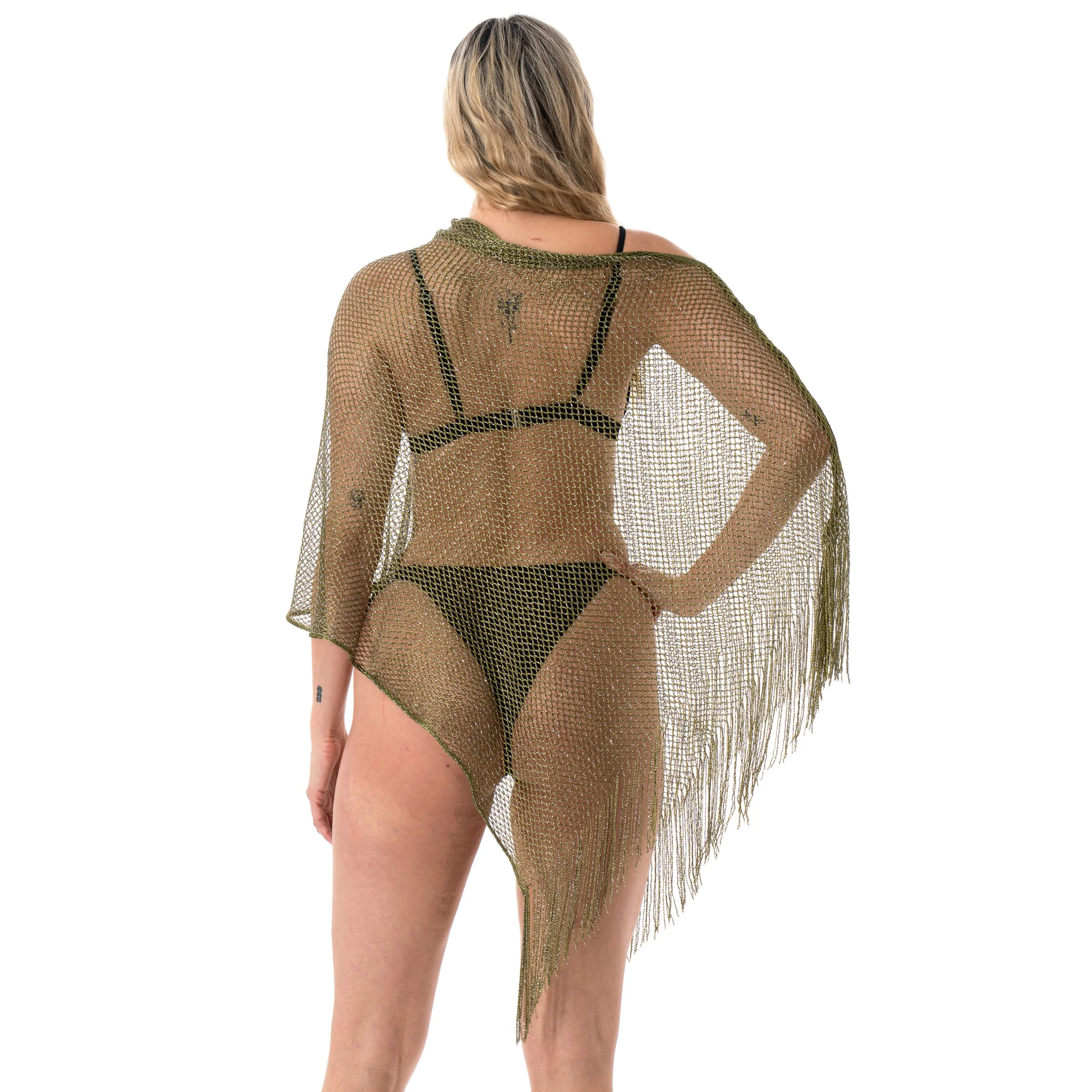 Woman wearing black lingerie and a sheer gold mesh shawl with fringe, standing against a white background.