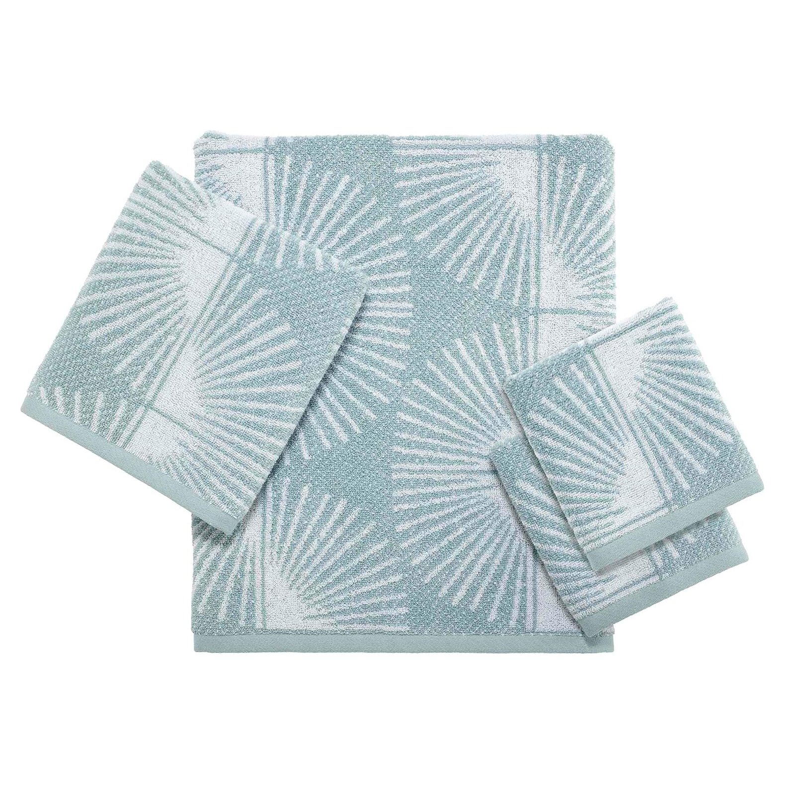 Set of four light blue and white patterned towels with a geometric palm leaf design.