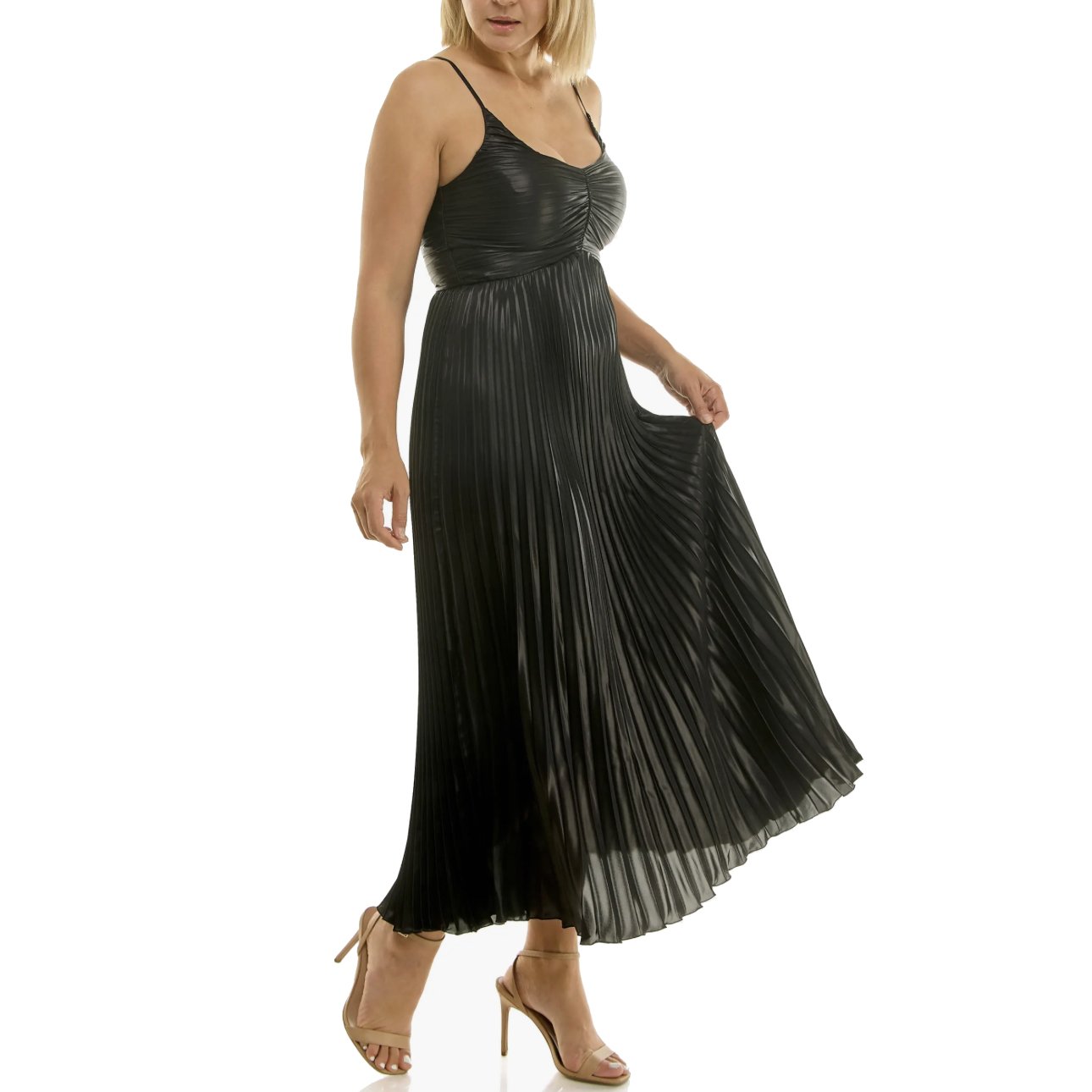 Woman wearing a shiny black pleated maxi dress and nude high heels.