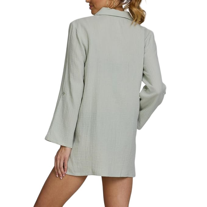 Back view of a woman wearing a light gray blazer with no visible pants or skirt.