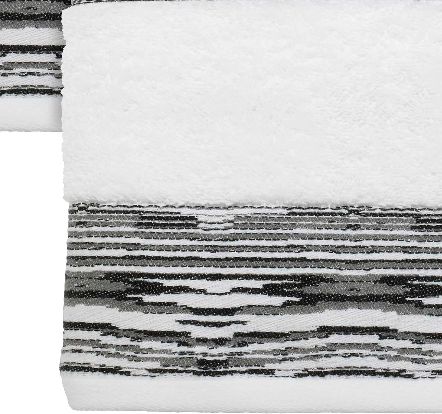 Close-up of a black and white striped textured fabric with a white paper or cloth overlay.