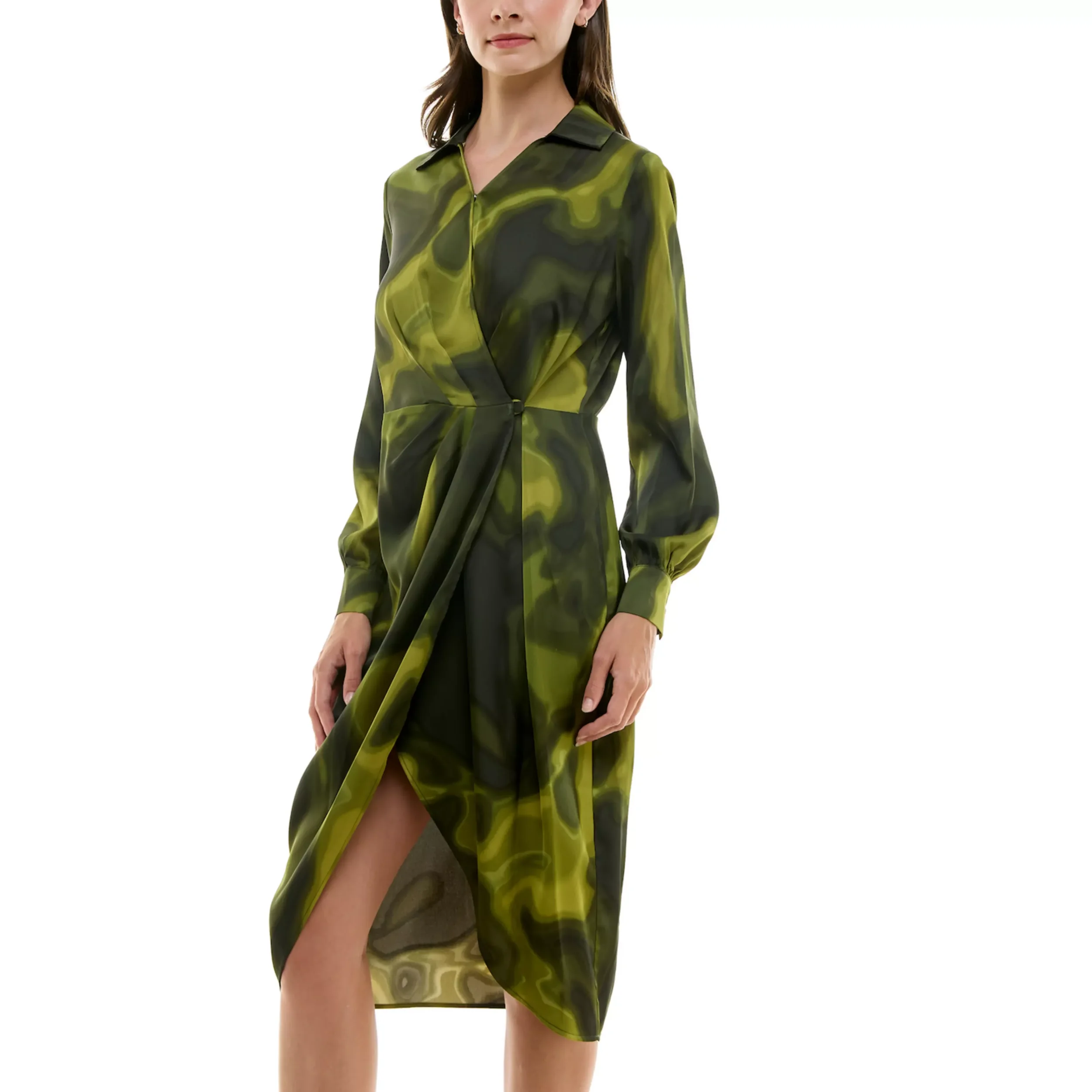 Woman wearing a long green and black patterned dress with long sleeves and a side slit.