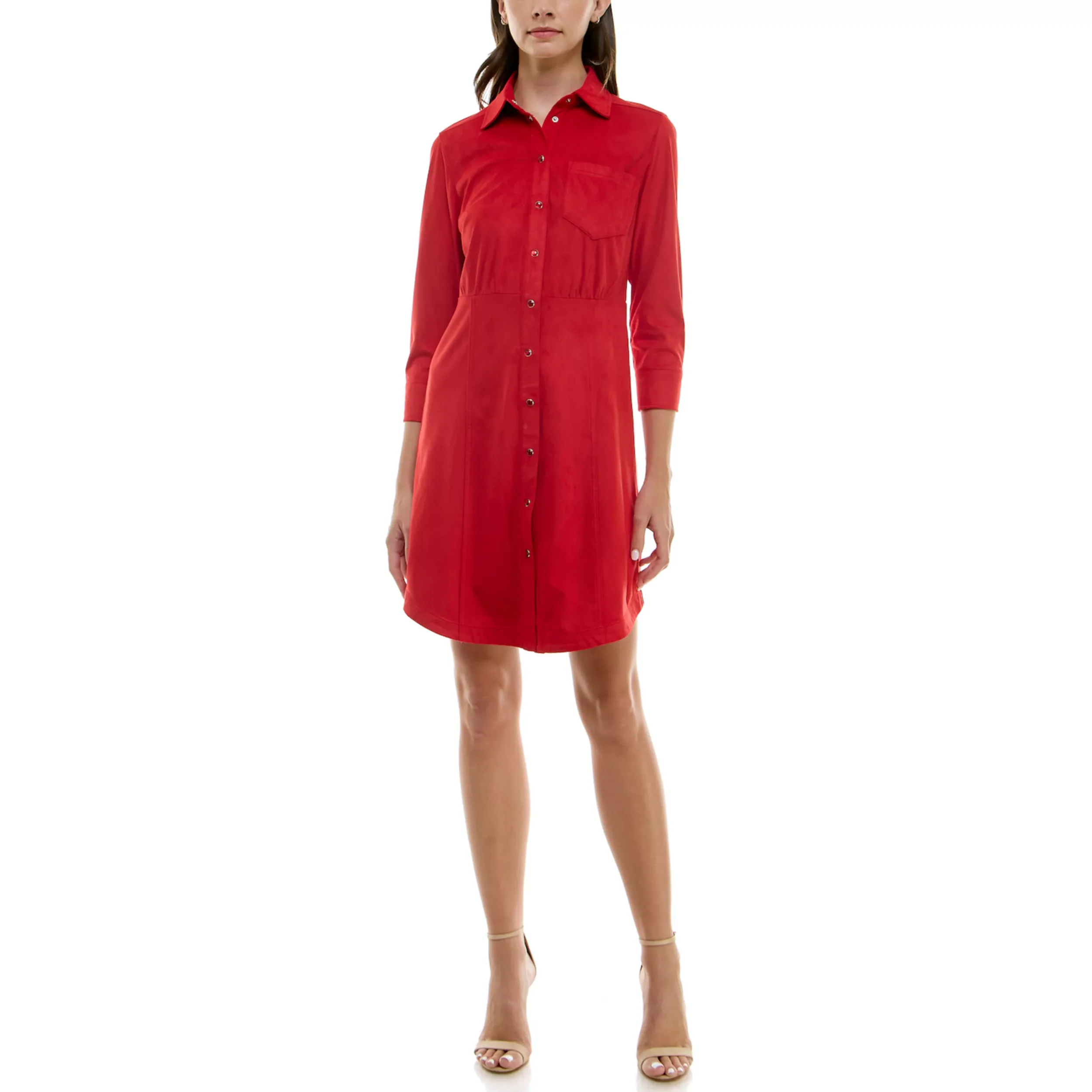 A woman wearing a knee-length red shirt dress with long sleeves, a collar, and button closure down the front, paired with beige high-heeled sandals.