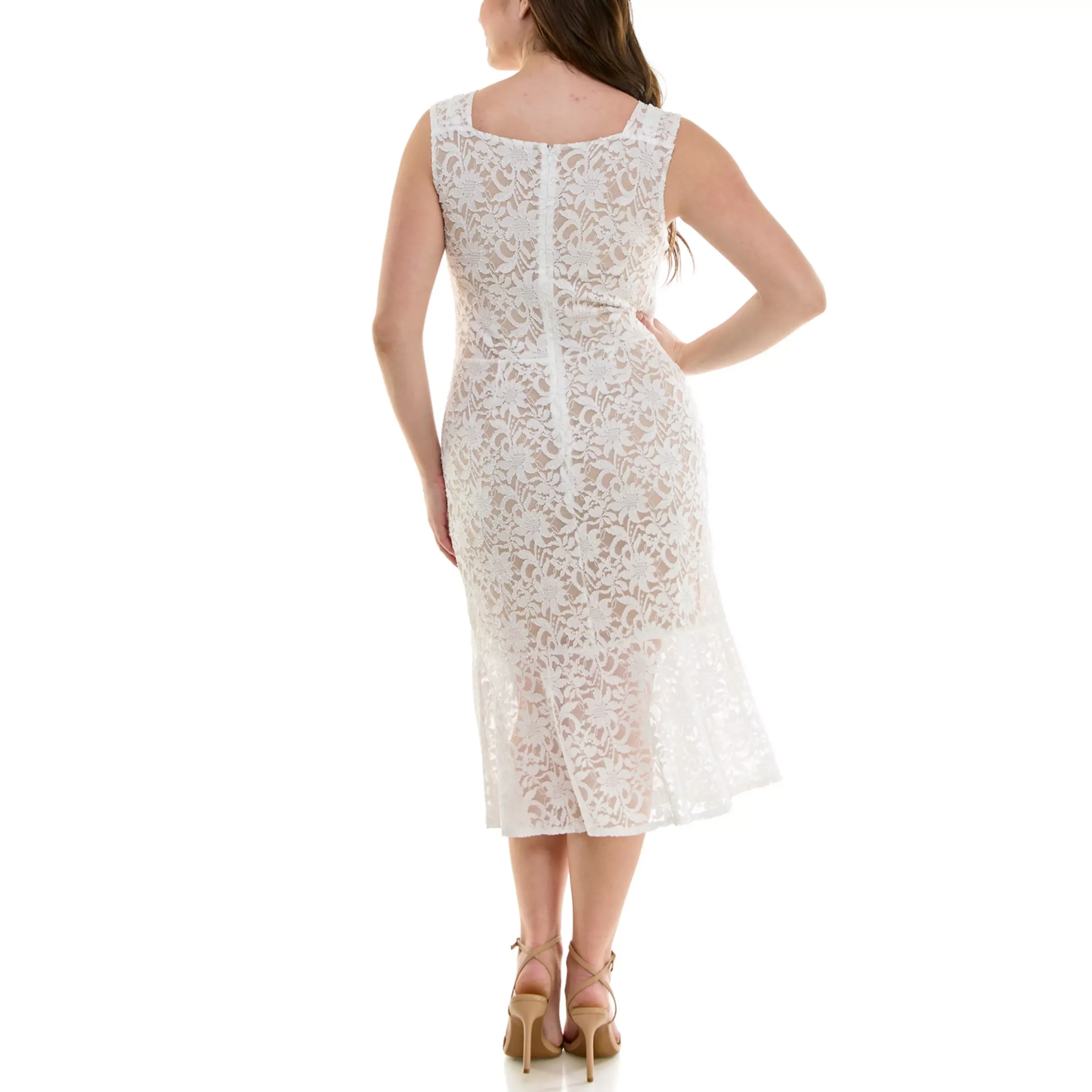 Woman wearing a white lace sleeveless dress with a scalloped hem, standing with her back to the camera, on a white background.