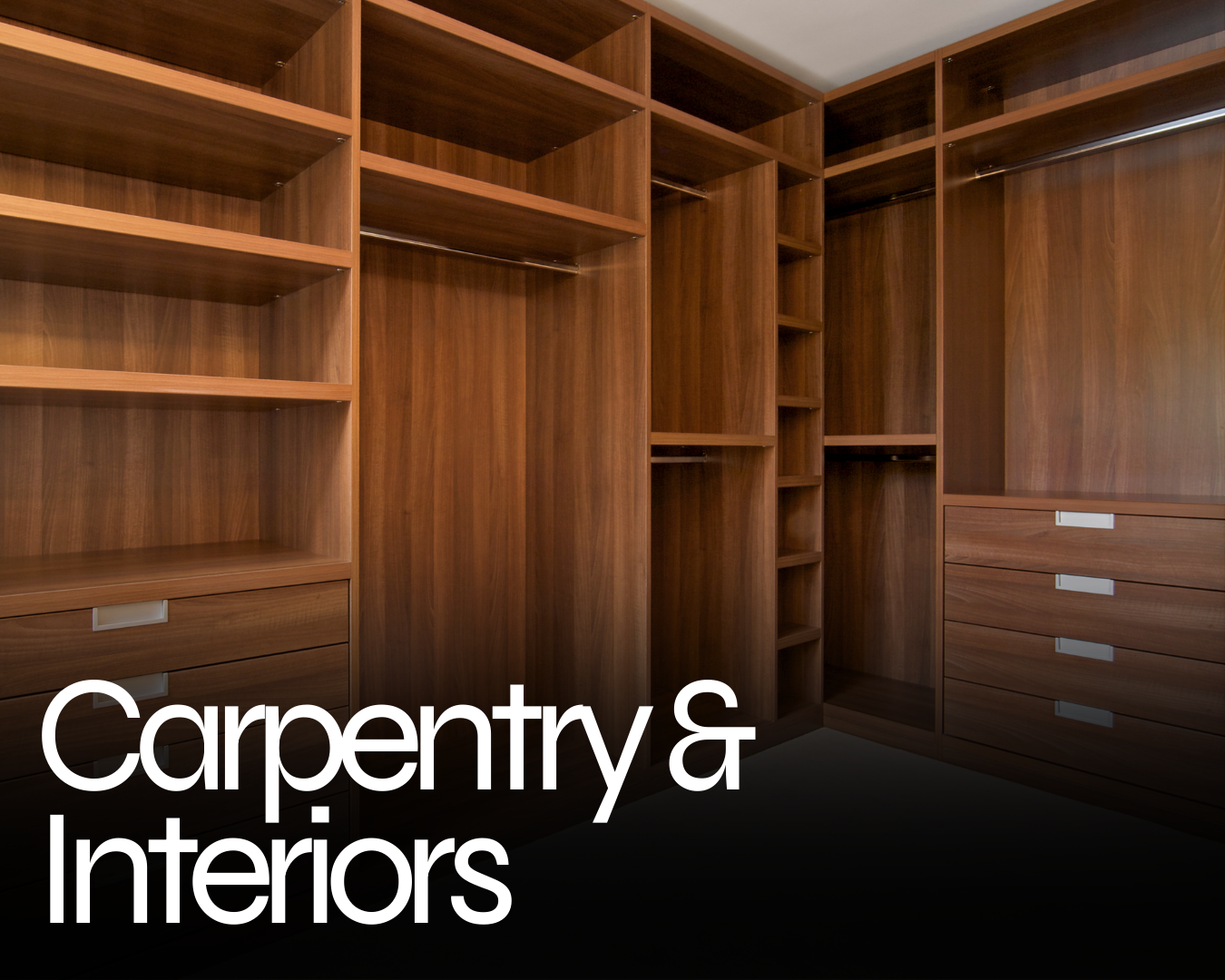 Bespoke Carpentry built-in wardrobe with shelves, drawers, and hanging rods.