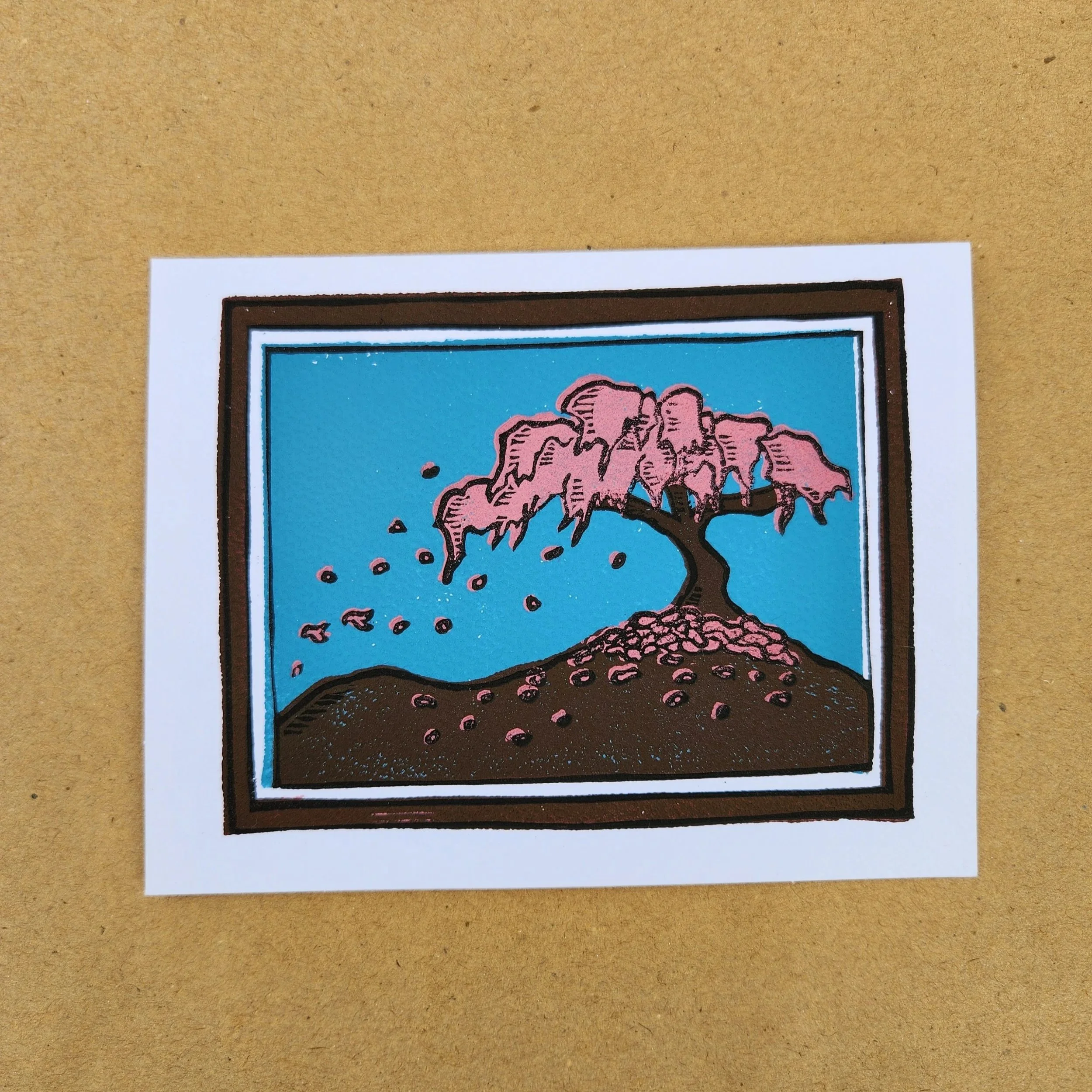 Illustration of a blooming pink cherry blossom tree on a hill with falling petals against a blue sky.