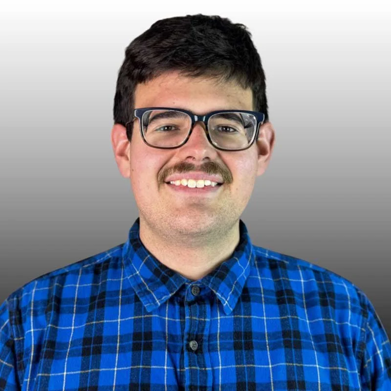 Portrait of Garrett Wygle, Christ In Action youth leader and volunteer, smiling in a blue checkered shirt.