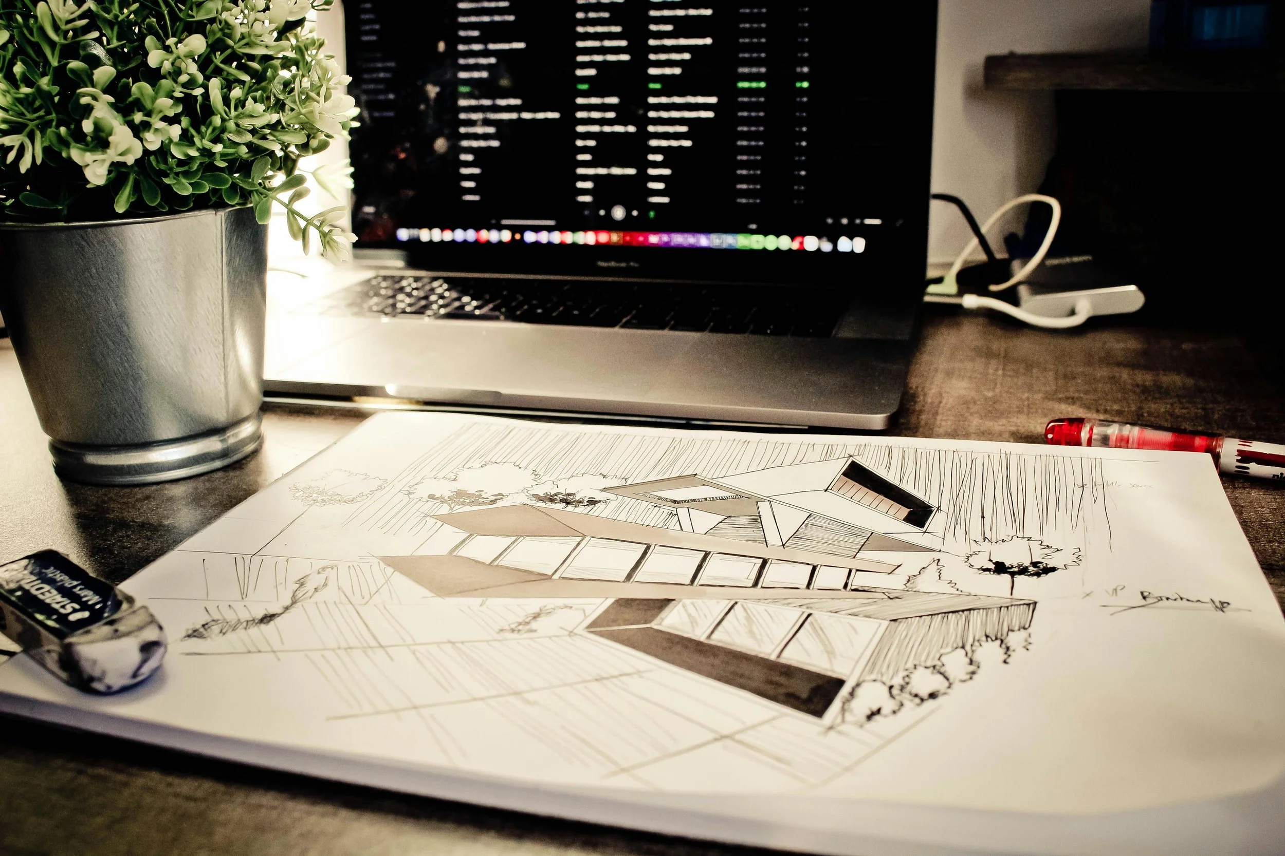 Desk workspace with renderings to explain a new concept.