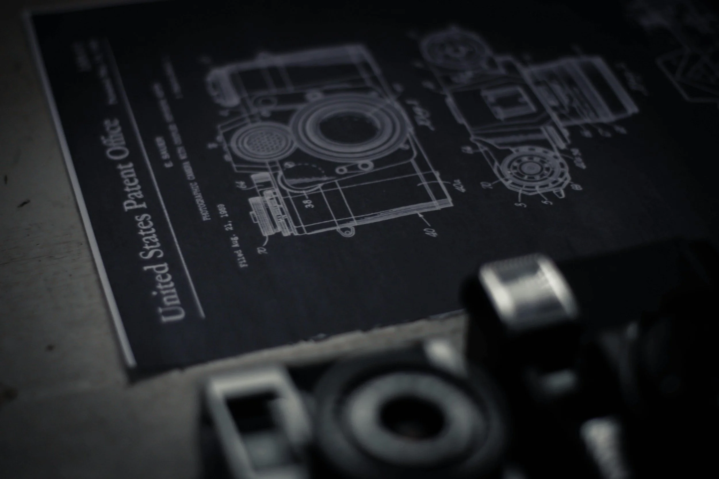 Blueprint of a mechanical device, with technical drawings and measurements, titled 'United States Patent Office'.