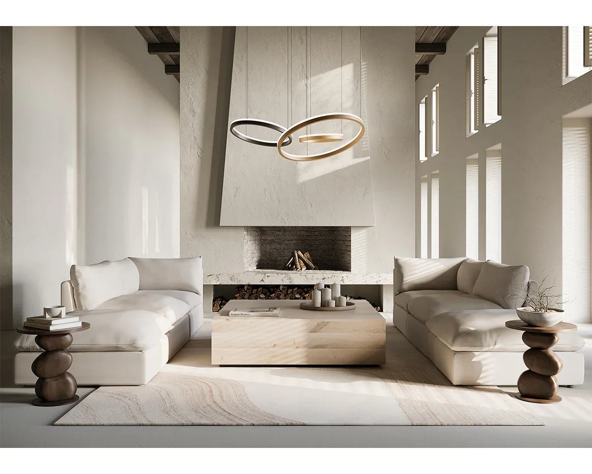 Modern living room with white sofas, a fireplace, and large windows letting in natural light. There are two wooden side tables, a minimalist chandelier, and a light-colored area rug.