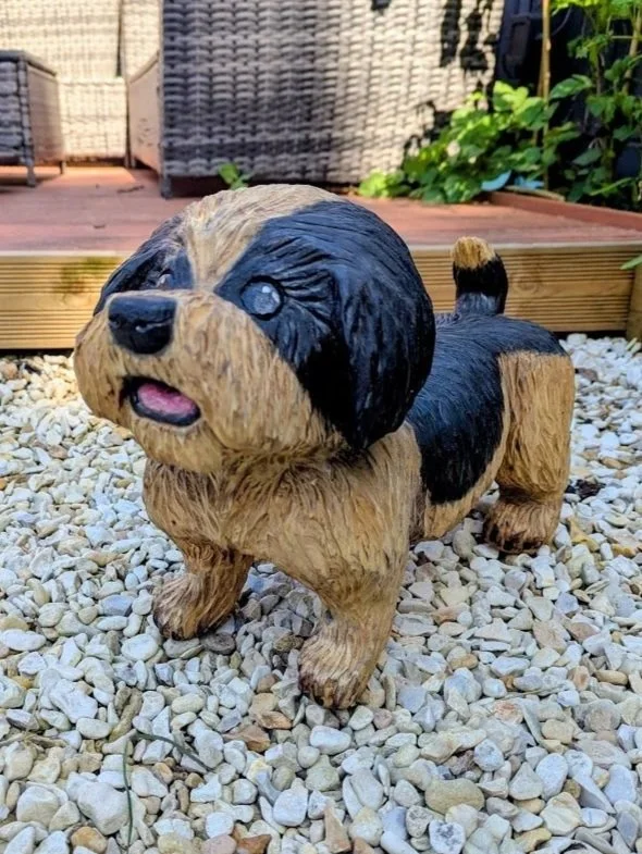 Custom Shih Tzu dog chainsaw carving handcrafted from solid wood using the customer's photographs.
