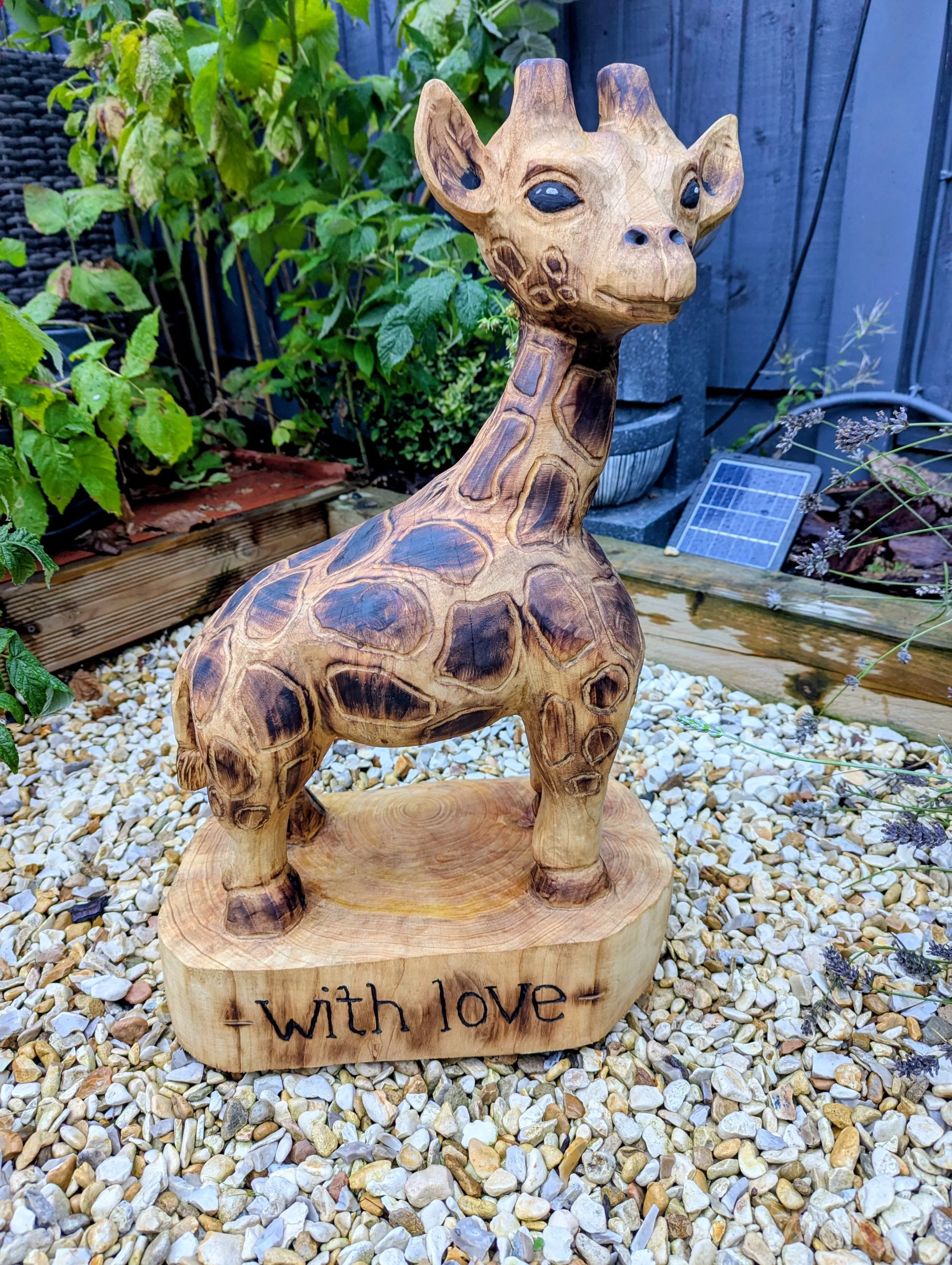 Chainsaw carved wooden giraffe garden sculpture handcrafted in the UK.