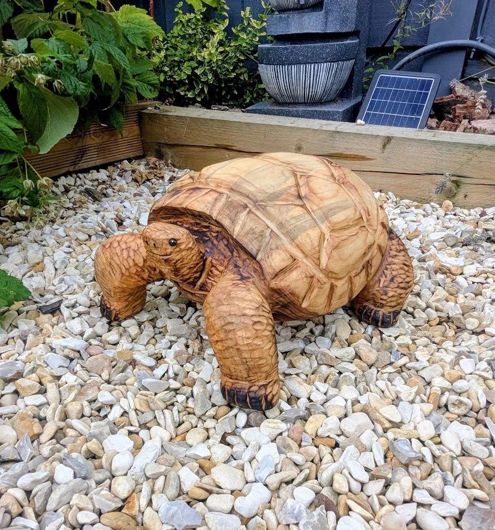 Chainsaw carved wooden otter garden sculpture handcrafted in the UK.