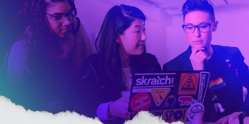 3 designers collaborating at a laptop