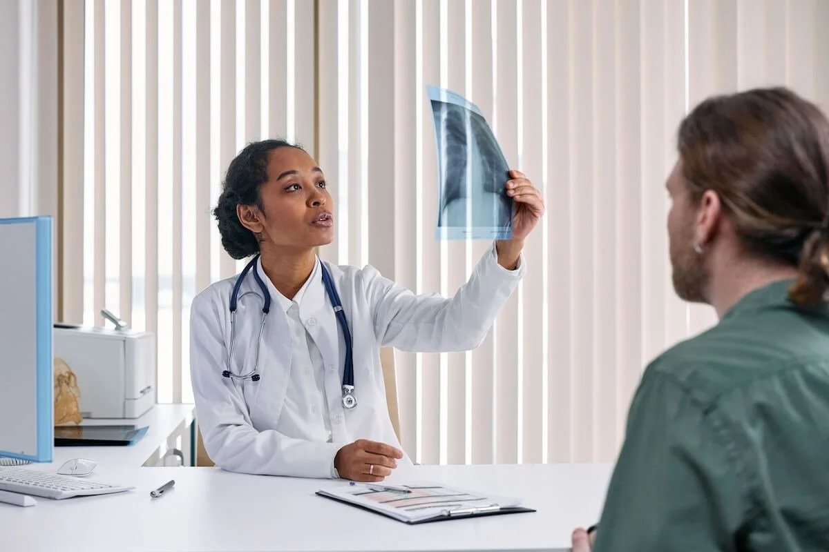A doctor reviews imaging results with a patient during a consultation, reflecting the thorough diagnostic process and detailed health history review that sets Functional Medicine in St. Louis, MO apart from standard care.