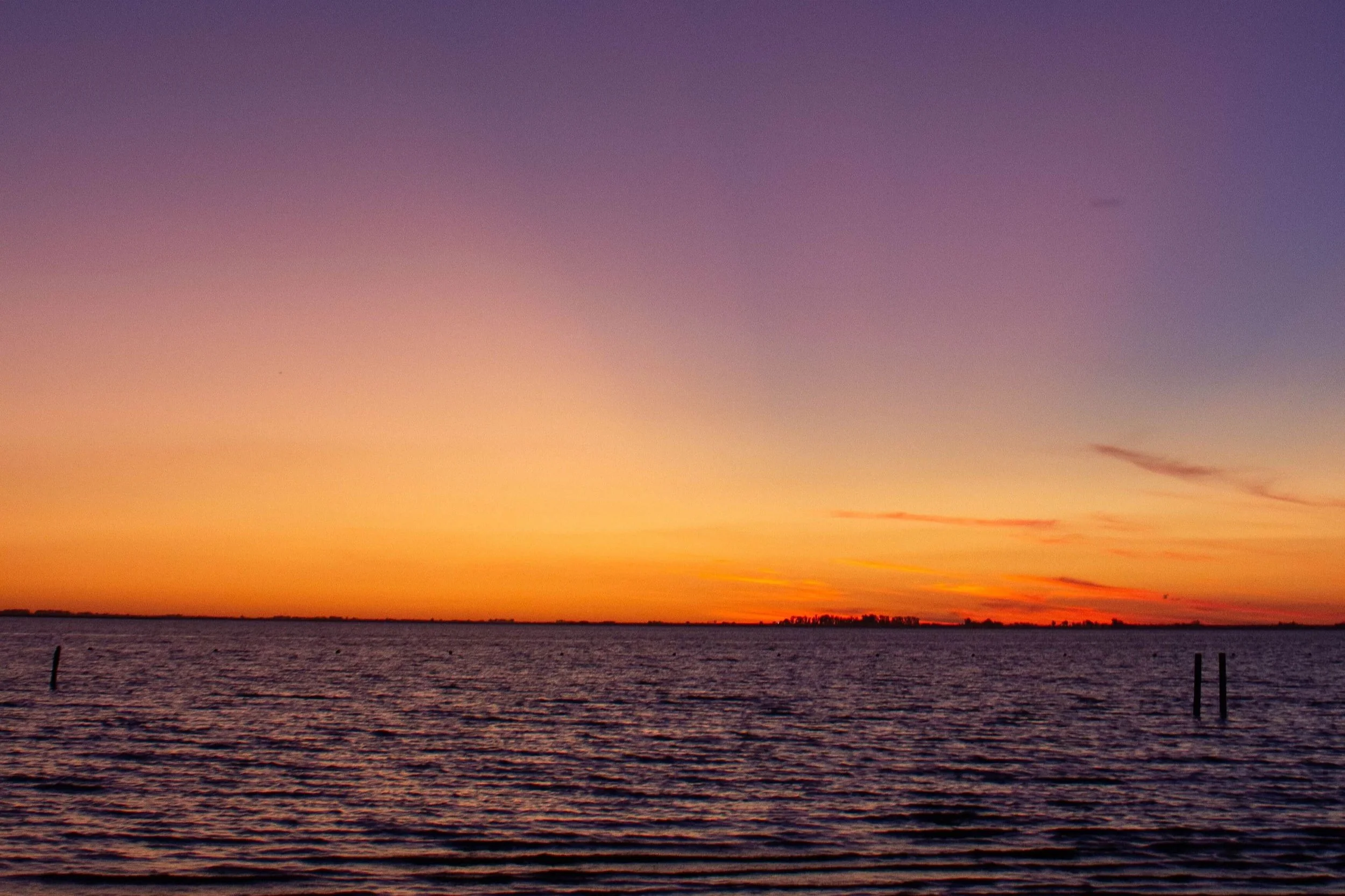 A vast, empty horizon glows orange and purple as the sun sets over calm water. What does it take to keep your relationship a priority long-term? A couples counselor in St. Louis, MO can help partners build lasting habits together.