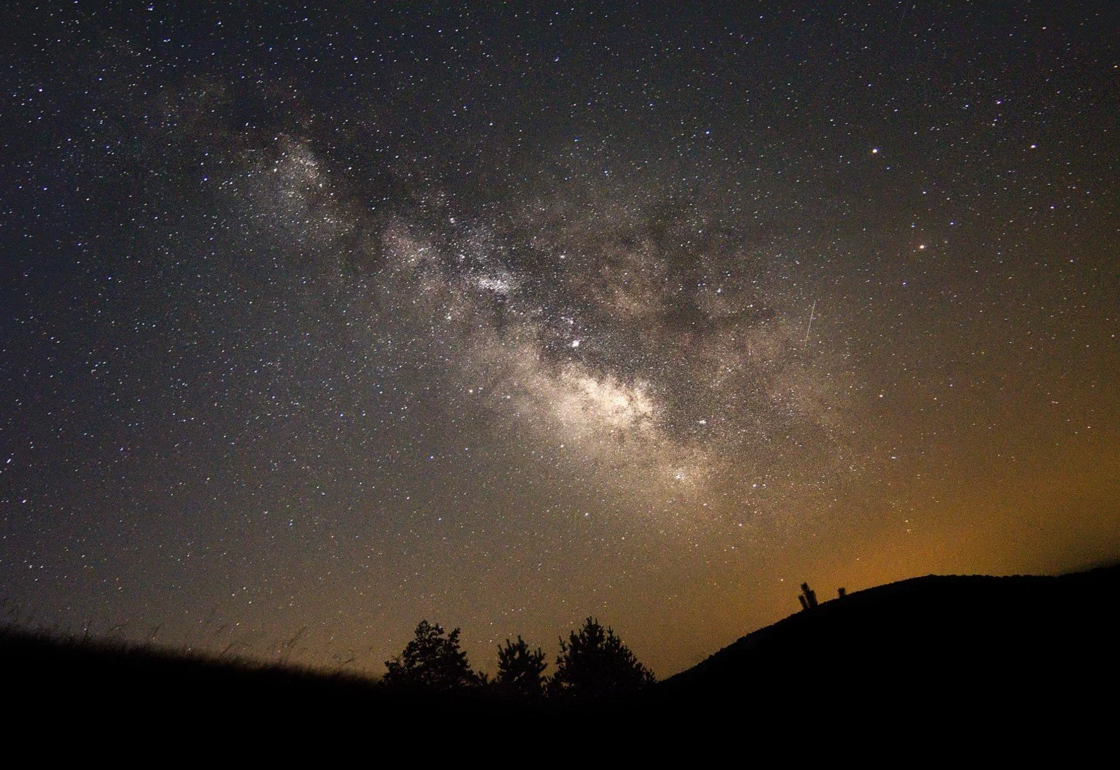 The Milky Way stretches across the sky above dark, tree-lined hills at night. Is emotional connection something you feel is missing when you're together? Couples counseling in St. Louis, MO can help you rebuild that sense of closeness.
