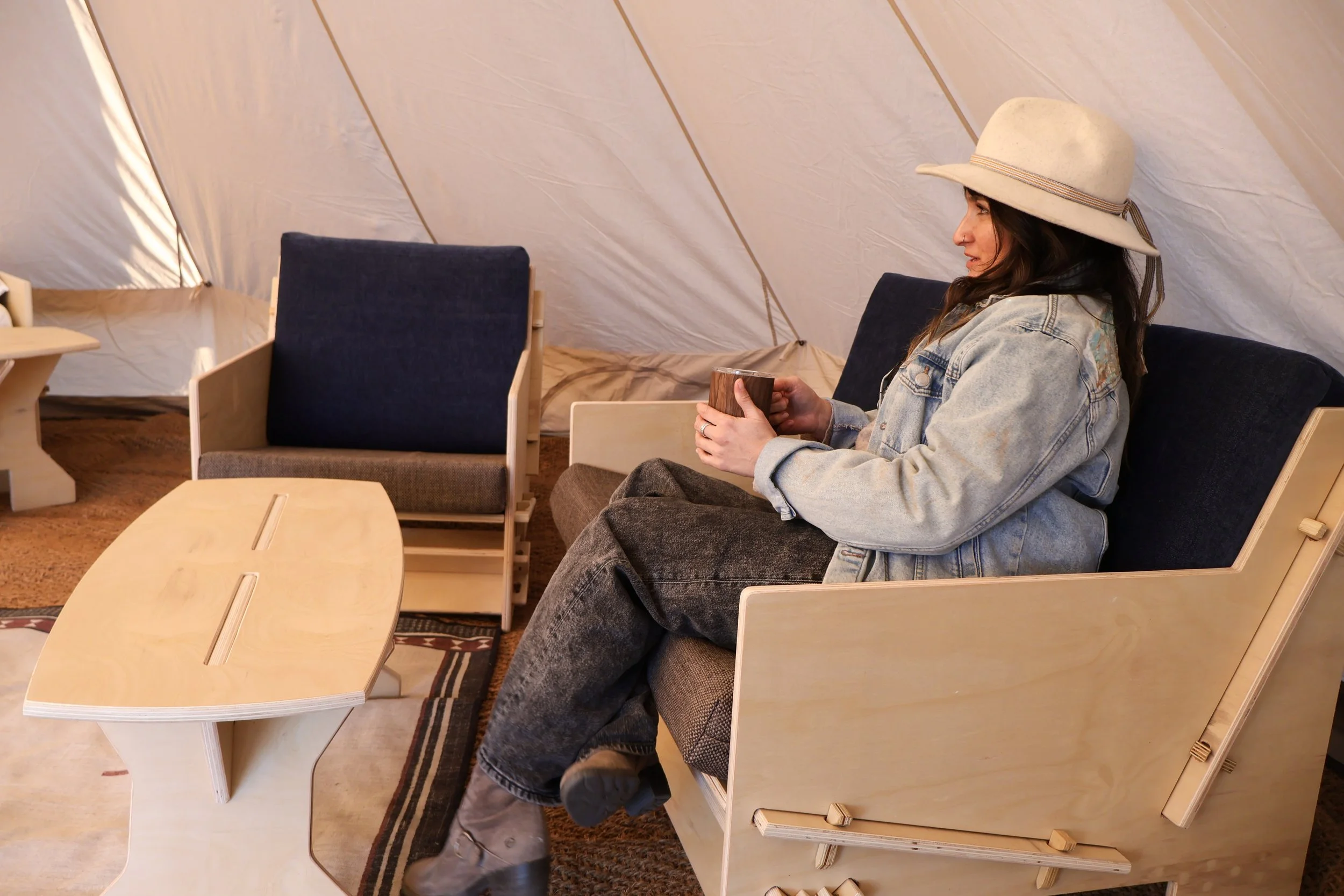 Woman relaxing while seated on Mustang Home Goods furniture.