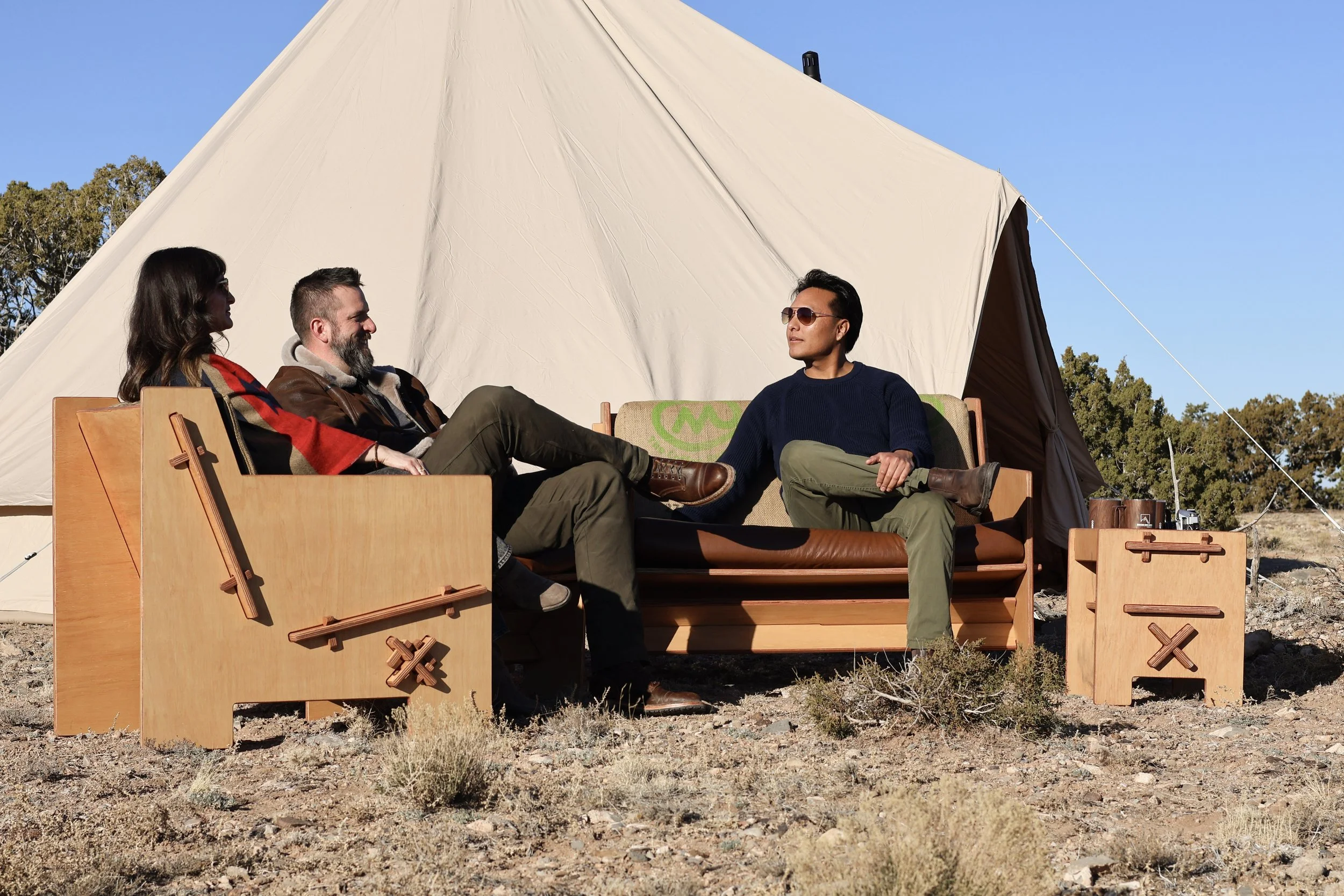People socializing outdoors on Mustang Home Goods furniture in a relaxed setting.