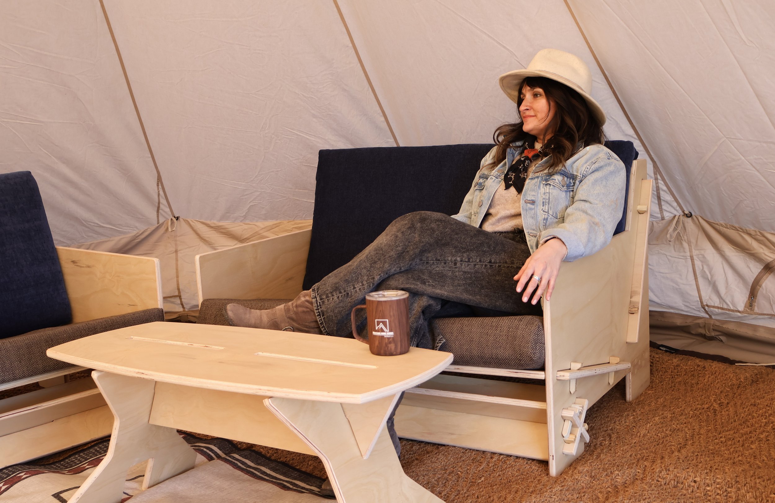 Woman relaxing comfortably on a Mustang Home Goods couch