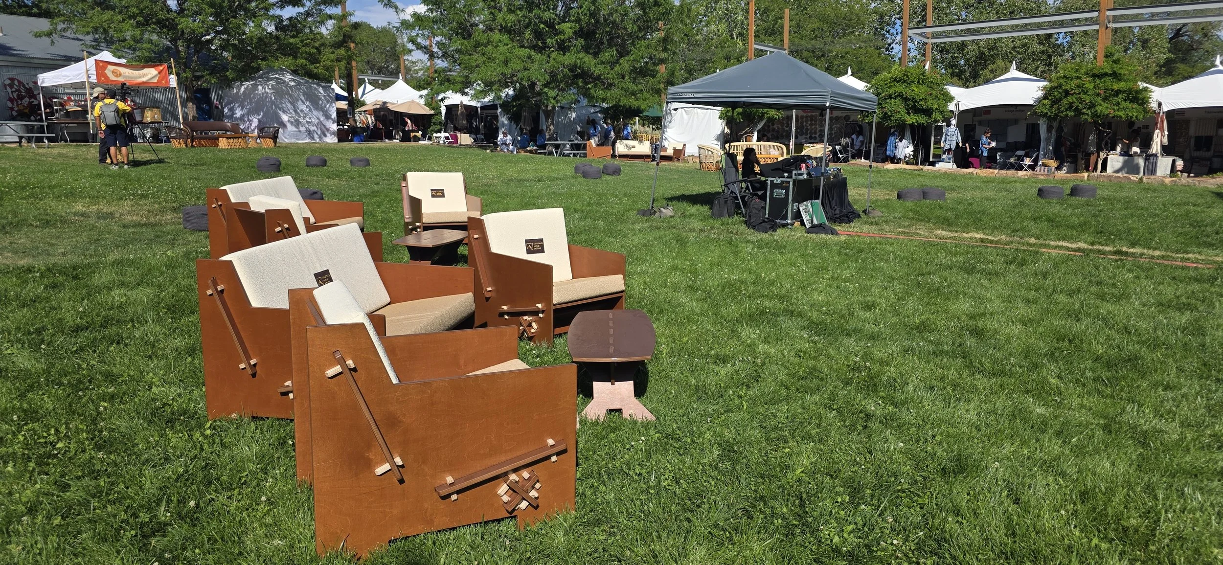 Outdoor display of Mustang Home Goods furniture during an event.