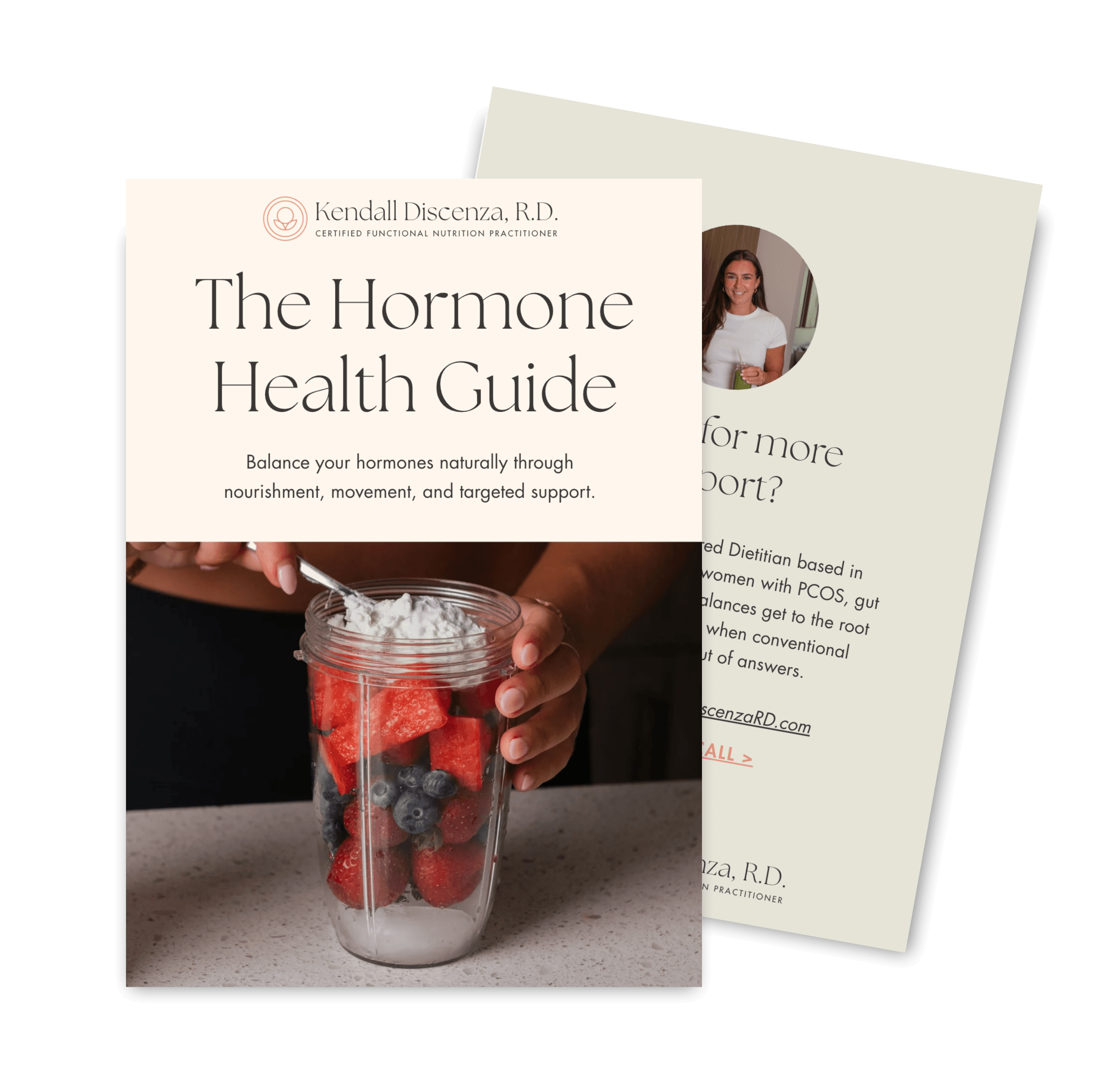 A clear glass filled with sliced strawberries, blueberries, and watermelon, topped with whipped cream, held by a hand in front of a black background with overlapping pages of a health guide and a photo of a smiling woman.