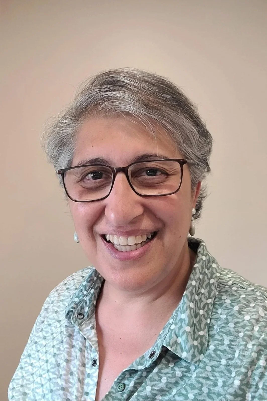 Headshot of Zermina wearing a blue shirt
