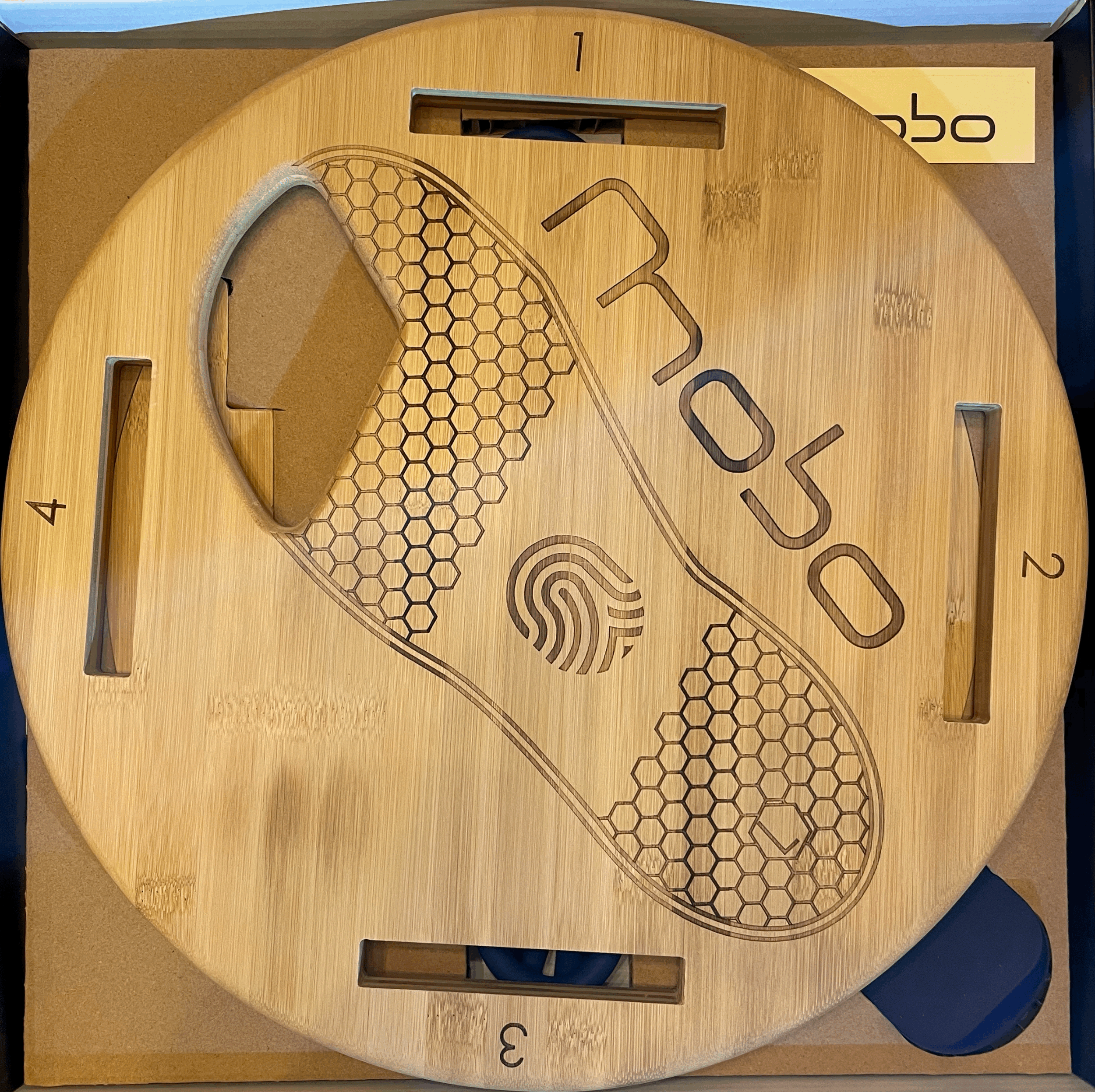 Unopened wooden hoverboard with engraved hexagon pattern, the word "HOVER" and a fingerprint symbol, numbered 1 to 4 at the edges.