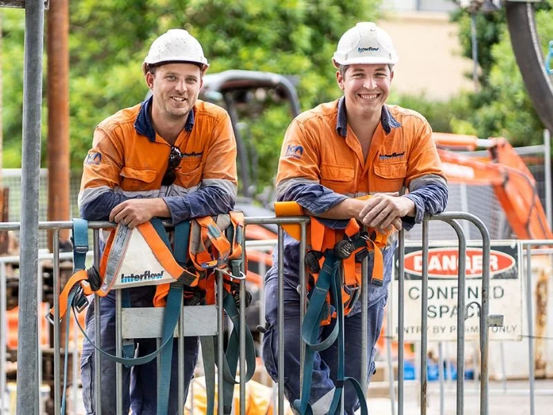 Workers wearing high-visibility workwear uniforms, representing reliable service and customer support.