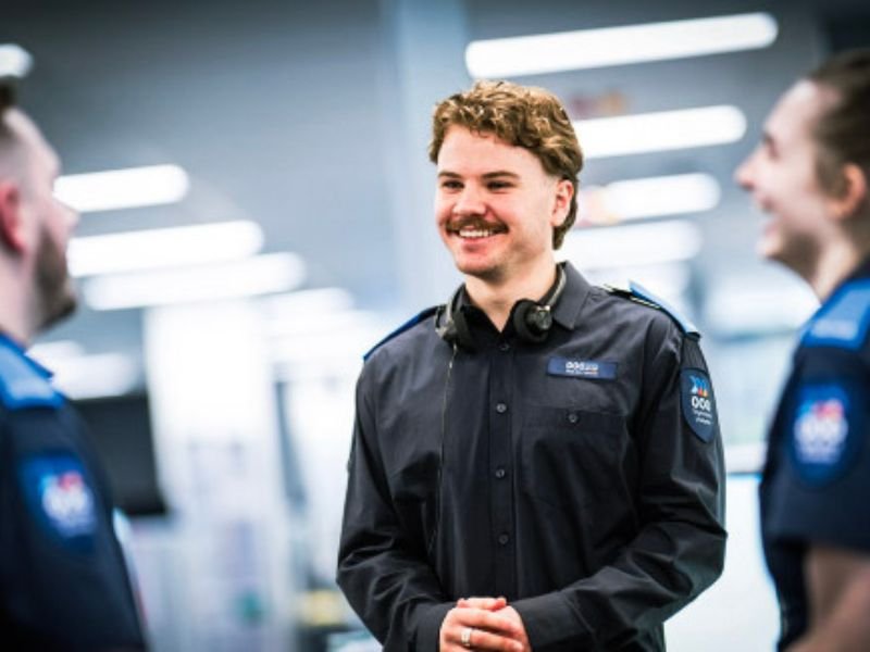 Professional services staff member wearing modern corporate workwear uniforms.