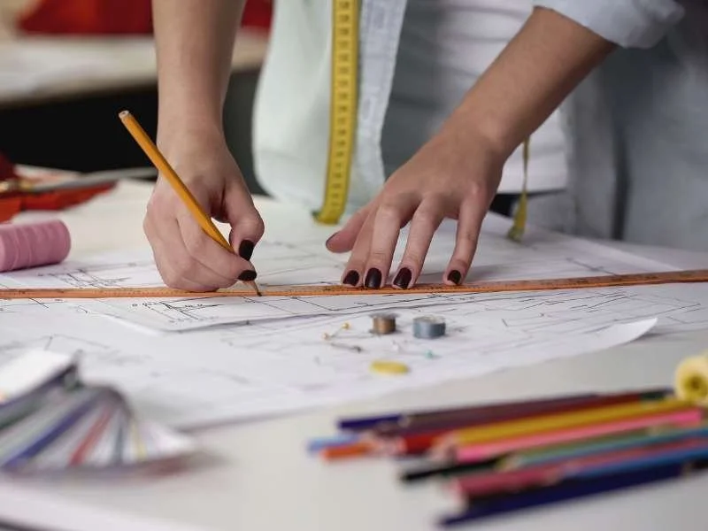 Designer sketching new workwear uniforms during the end-to-end design process.