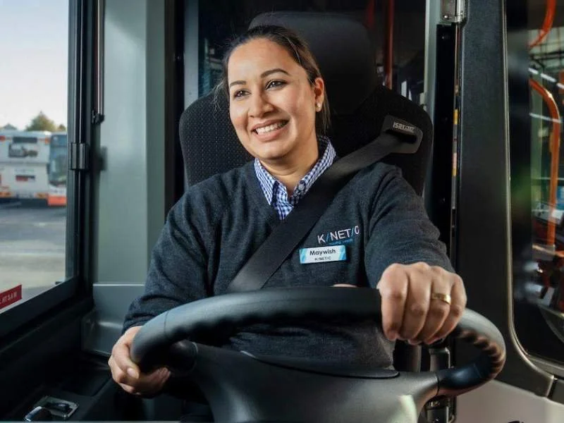 Transport and logistics worker wearing functional workwear uniforms while operating a vehicle.