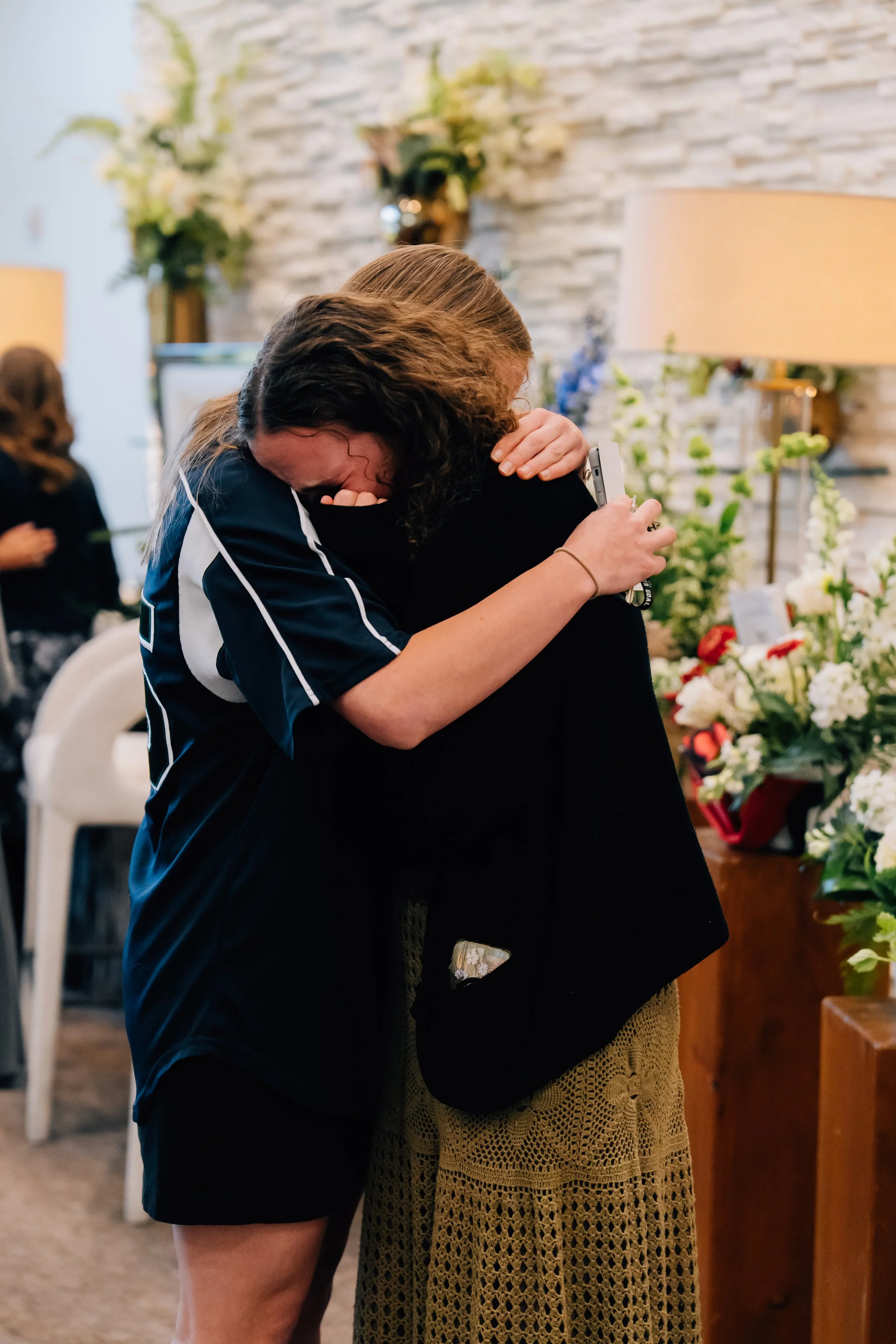 Friends and family mourning the loss of Noah Scribner at his viewing prior to his funeral.