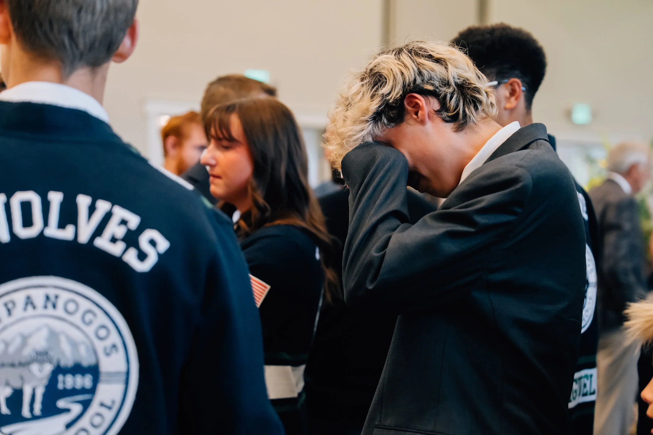 Friends and family mourning the loss of Noah Scribner at his viewing prior to his funeral.