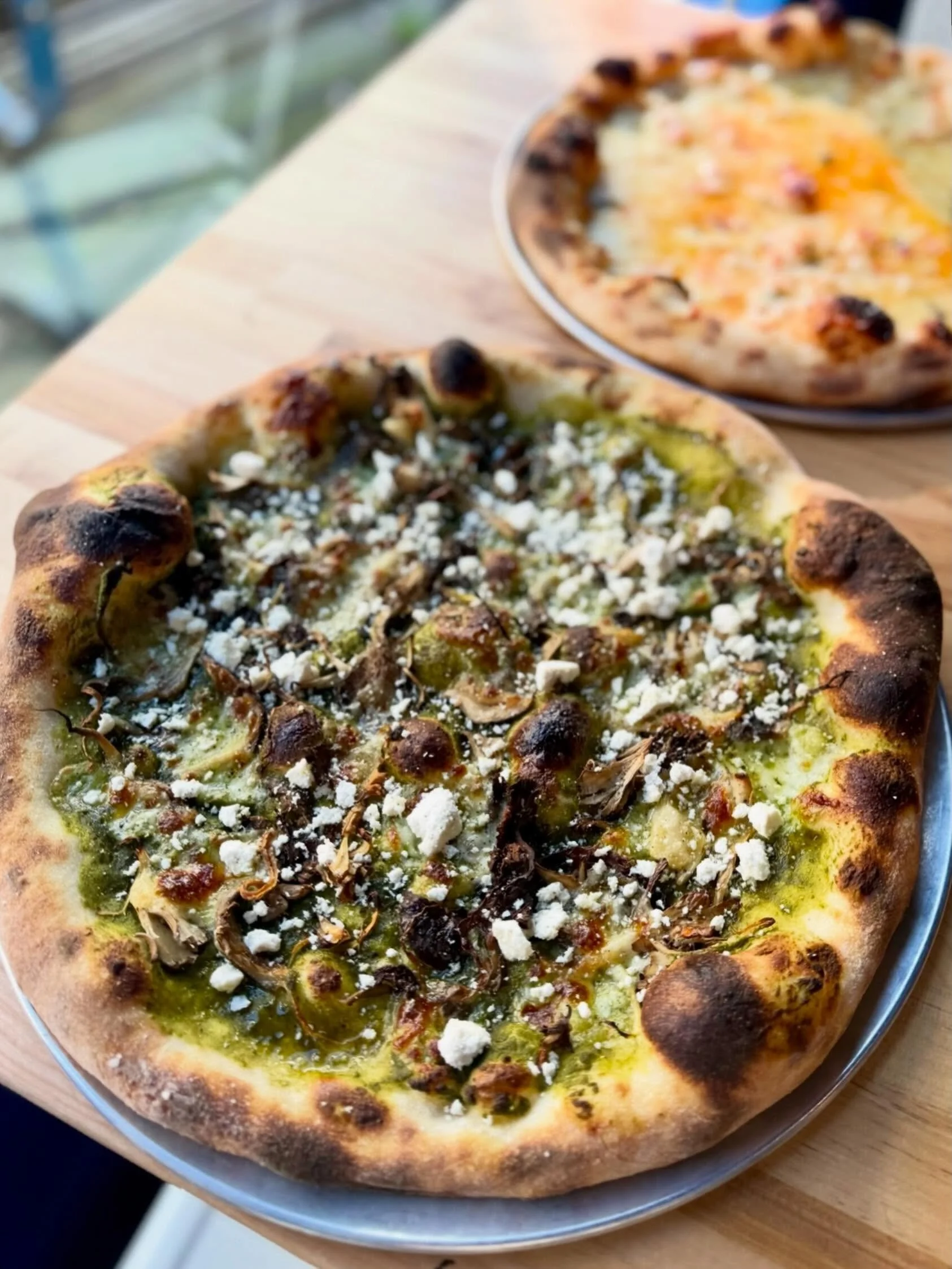 Among Us 🍄&zwj;🟫 a fully fungus fledged pizza with a grassy spring pesto made from green garlic and pea vines, topped with ricotta salata. 

On the menu in Queen Anne!

#queenanneseattle #seattlepizza #mushroompizza #naturallyleavened #seattleresta