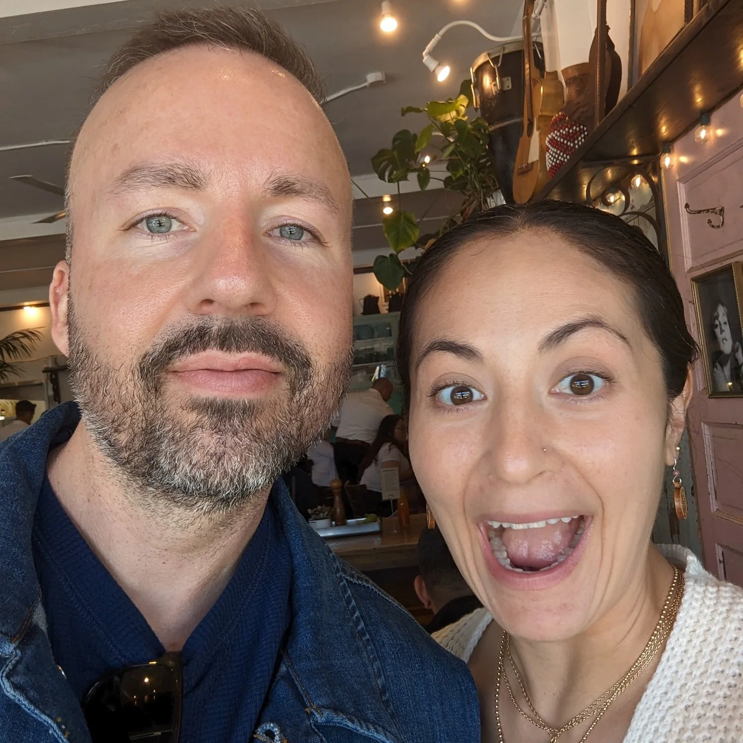 Two people looking at the camera taking a photo.