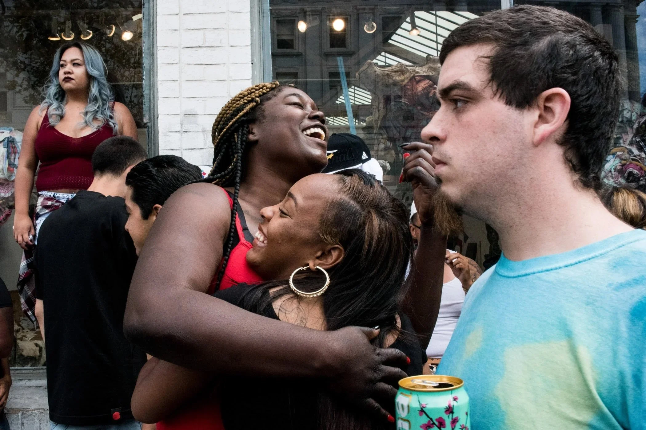 Two African American women hug each other during a Pride Parade in San Francisco.