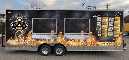 Food truck for Pablo's Tacos with grill menu and fire graphic design.