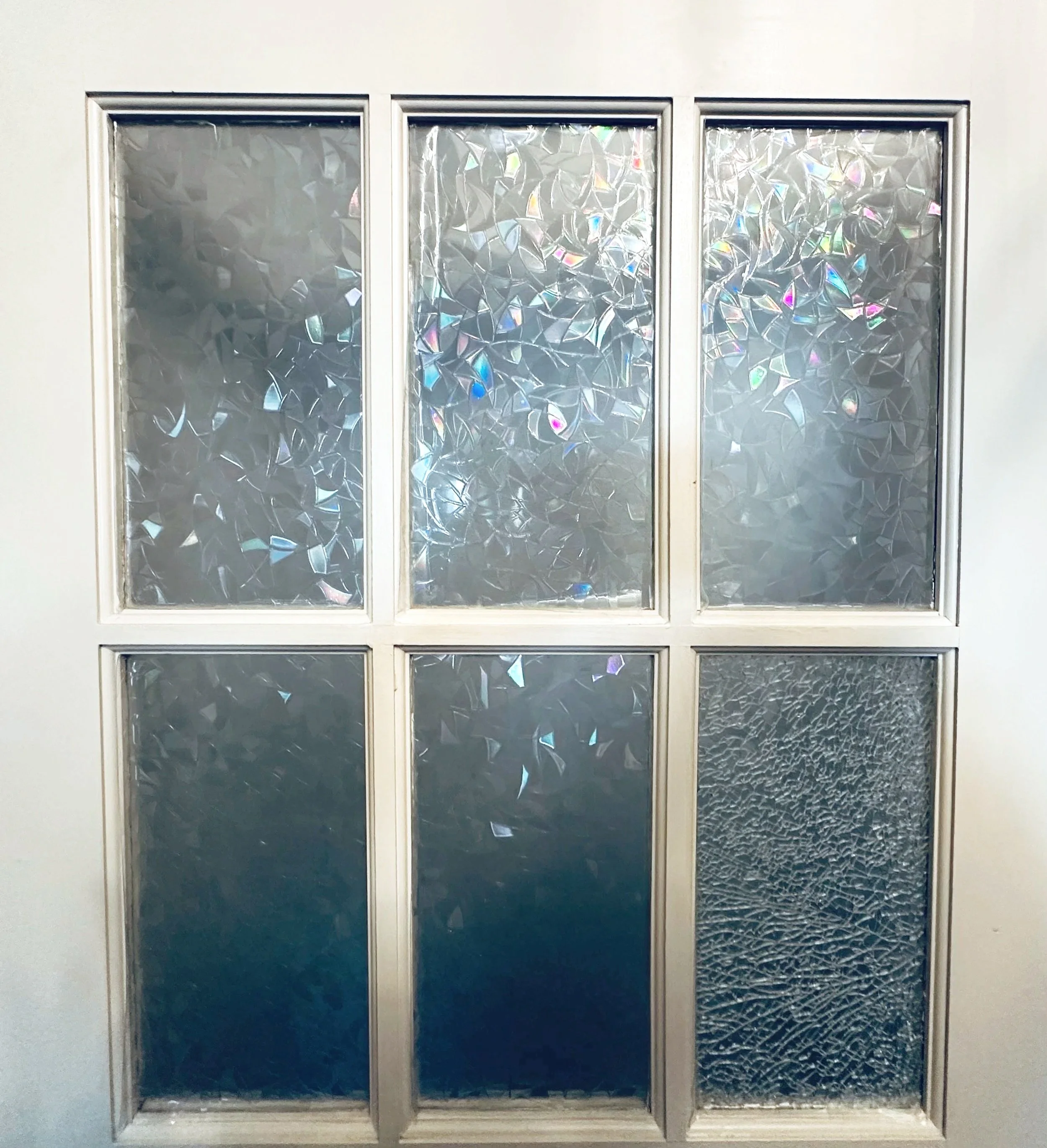 6-panel glass window with textured and patterned glass, some panels have iridescent and crackled glass effects.