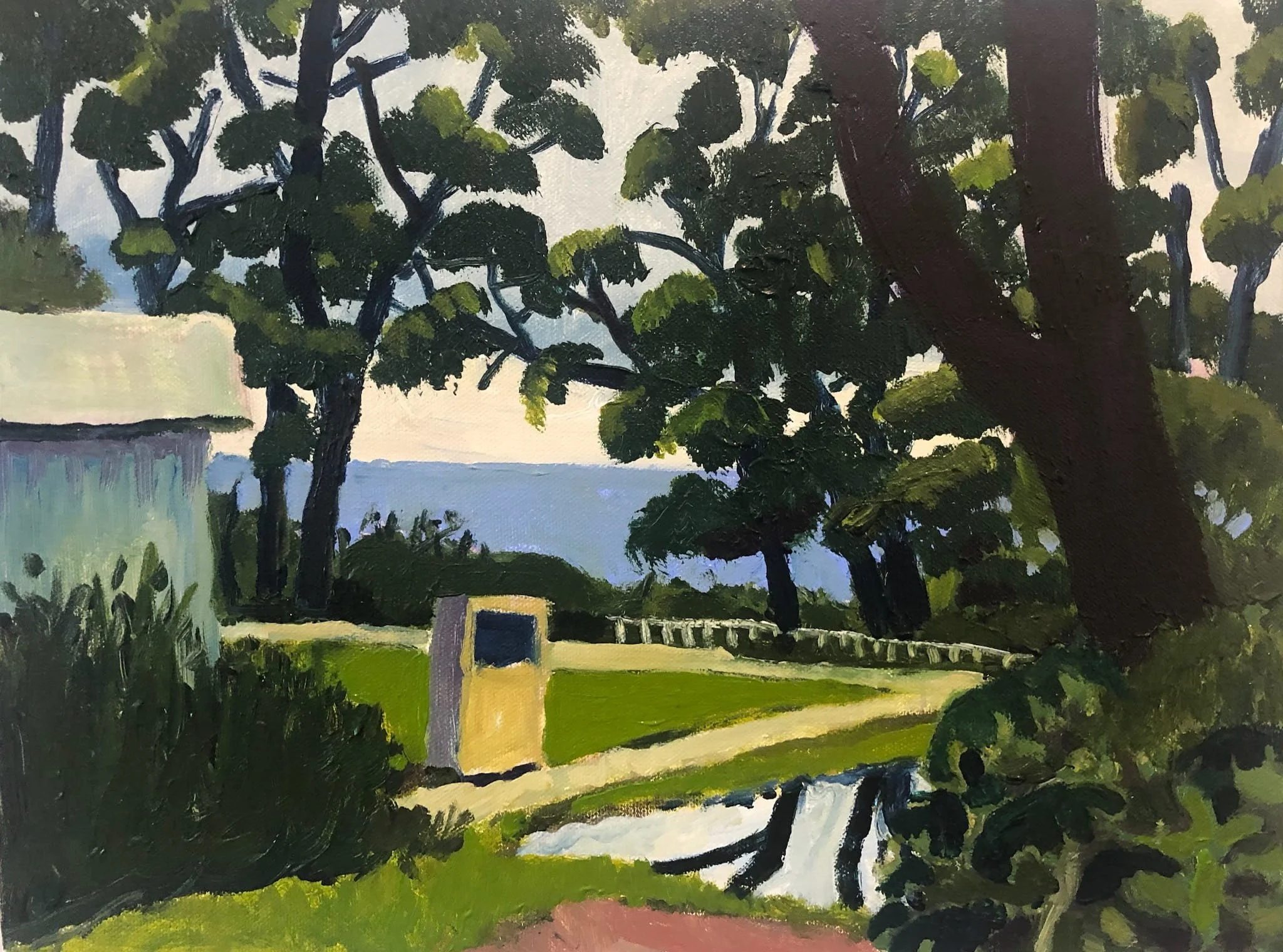 Landscape painting of an Australian park with large trees, a small yellow building, a bridge over a stream, and a view of the ocean in the background. Art by Peter Gowans.