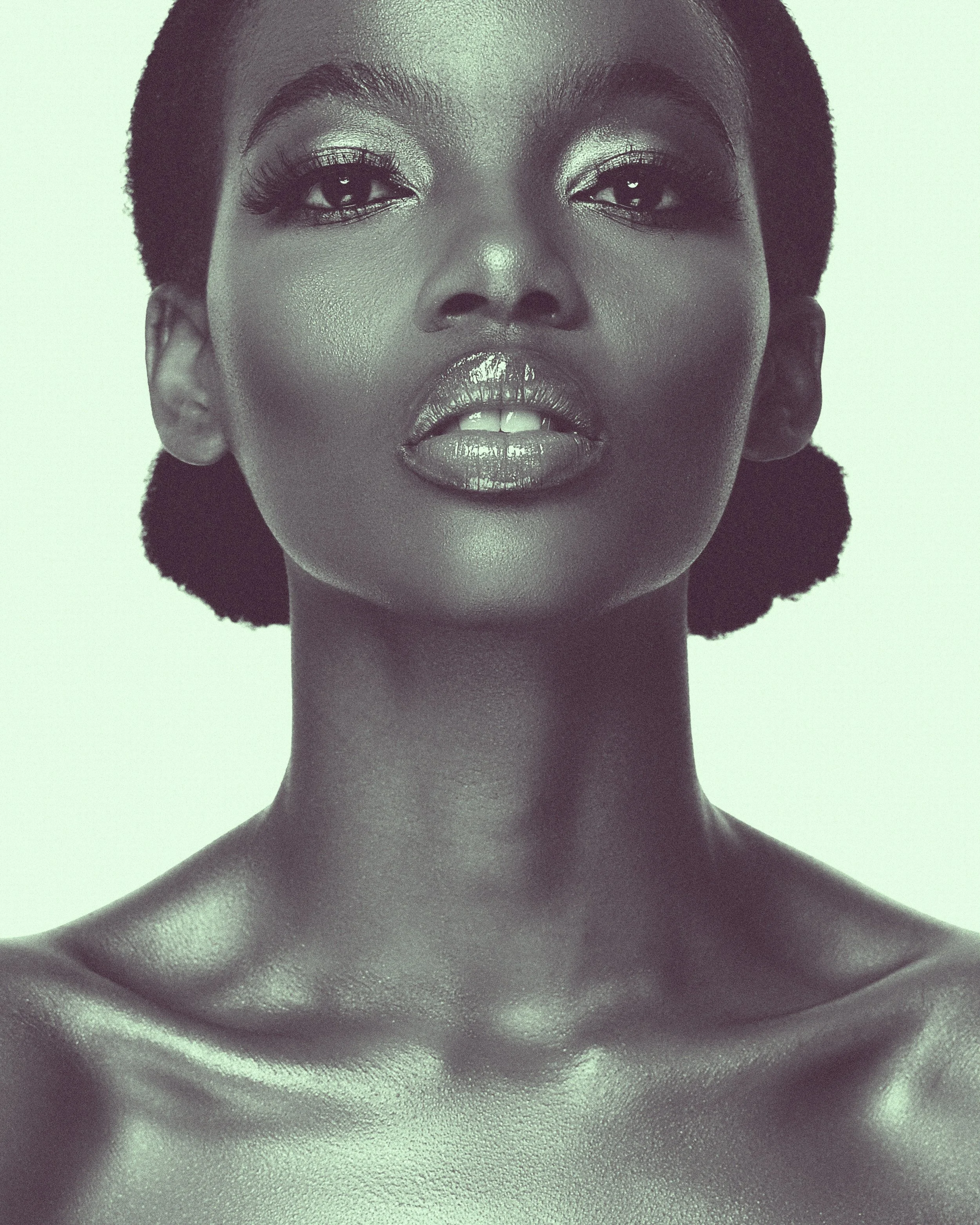 Black woman with short hair and glossy lips, looking directly at the camera with a confident expression.at Signature global Talent