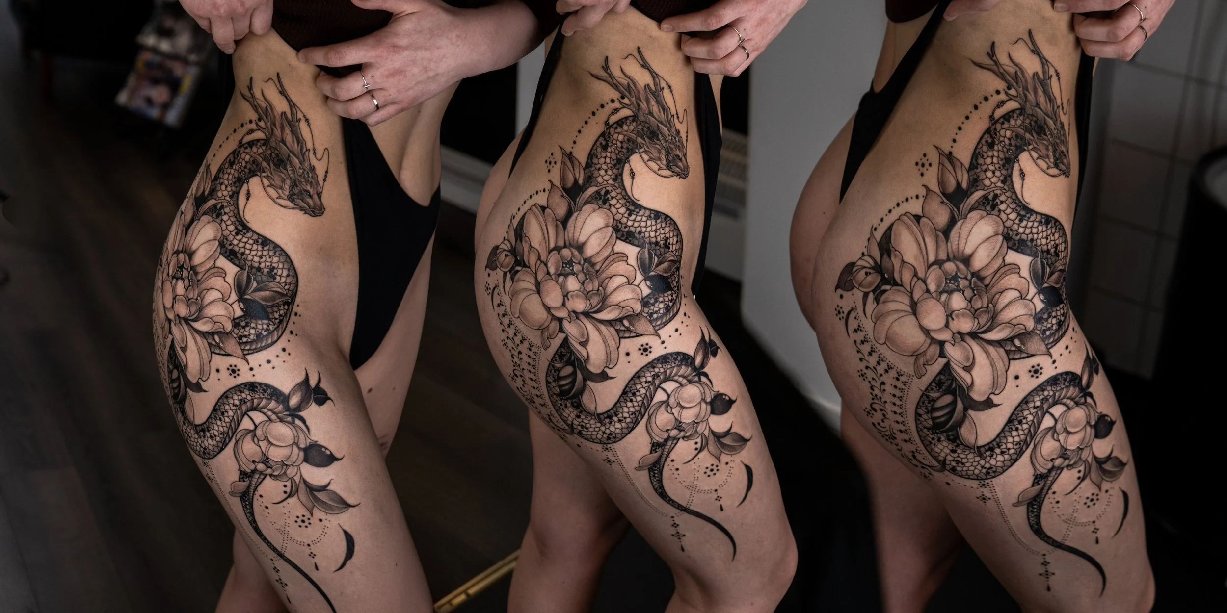 Tatuerad orm och blommor på en persons ben