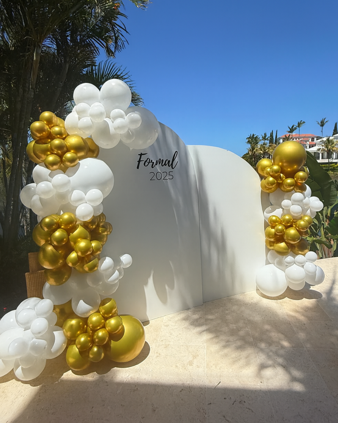 Gold and white balloon styling and backdrop 