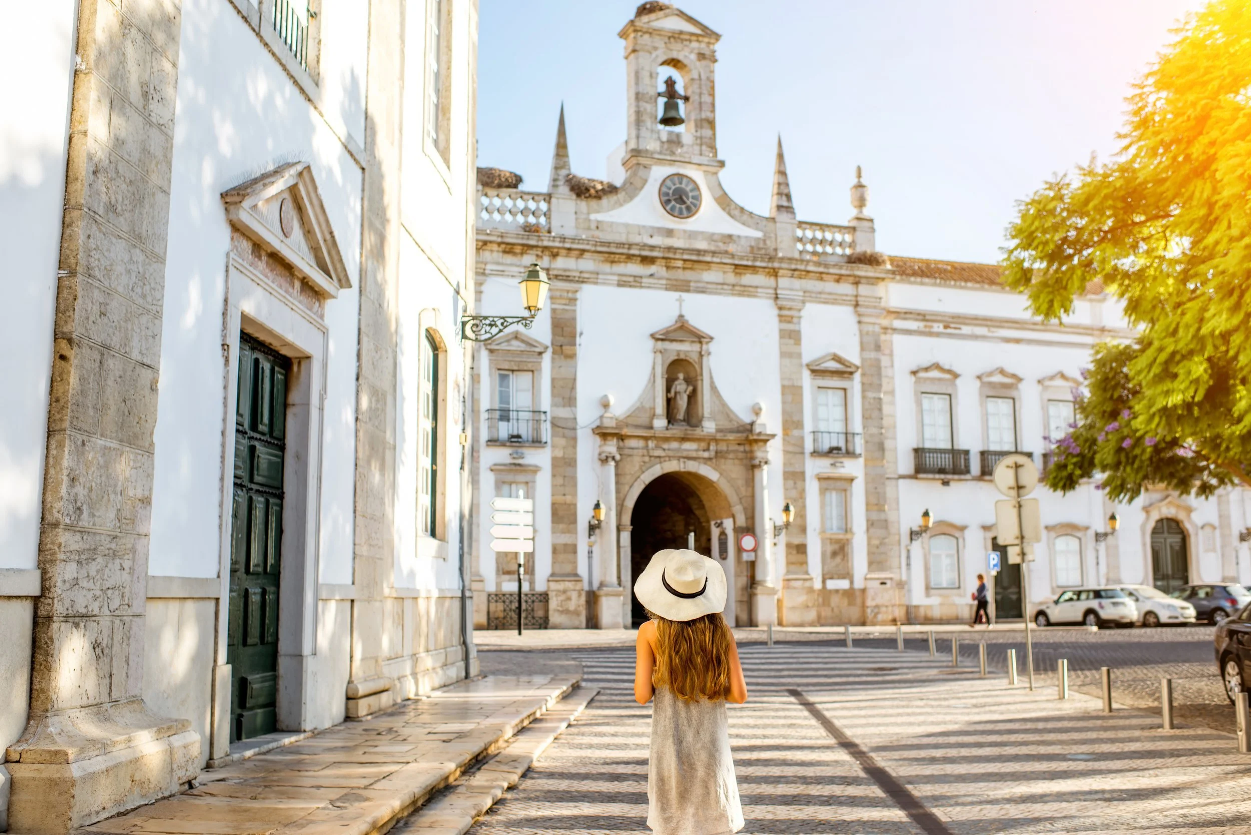 A young woman in the streets of Faro, Portugal. Beautiful buildings.